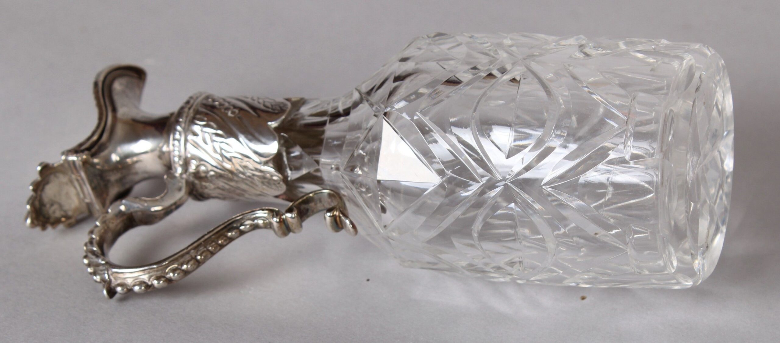 George II silver oil and vinegar cruet with original cut-glass bottles