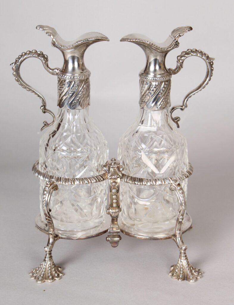 George II silver oil and vinegar cruet with original cut-glass bottles