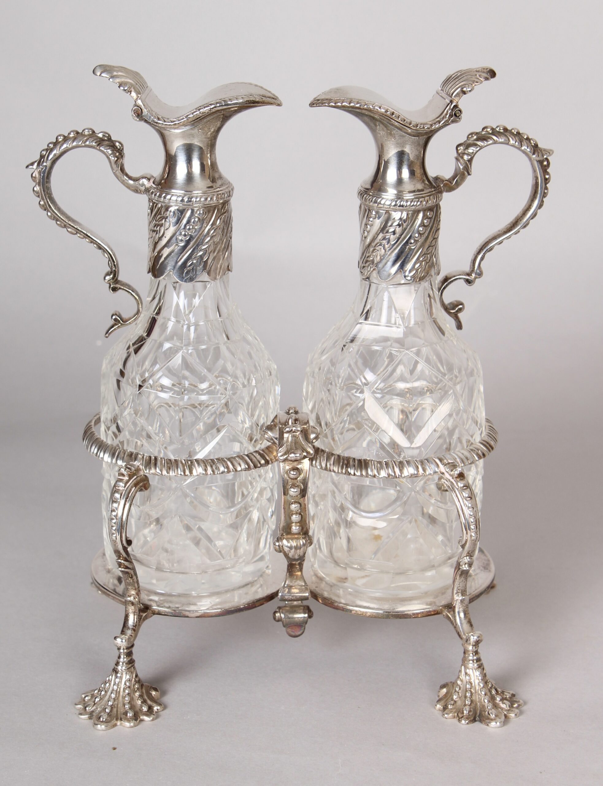 George II silver oil and vinegar cruet with original cut-glass bottles