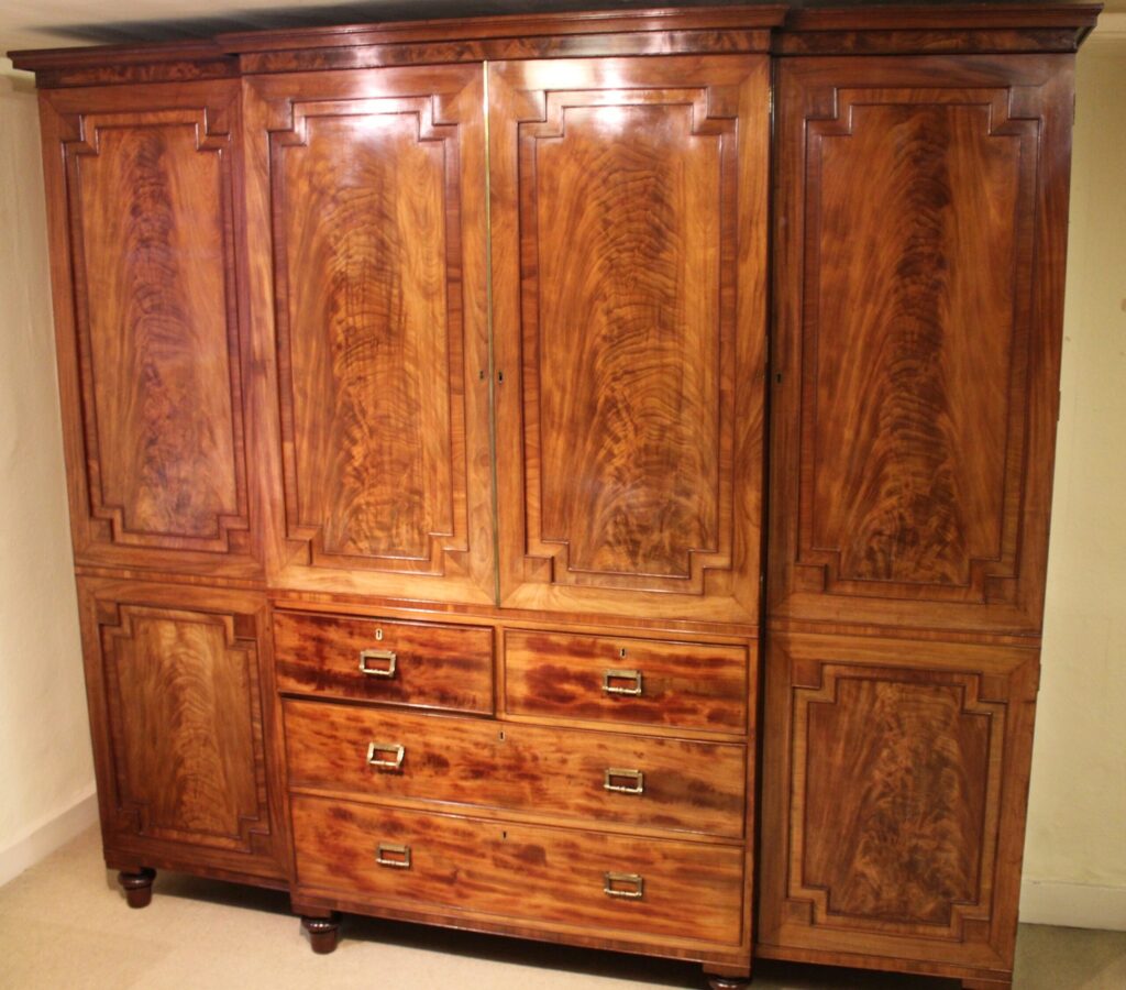 George IV period mahogany breakfront wardrobe of exceptionally fine figure and colour