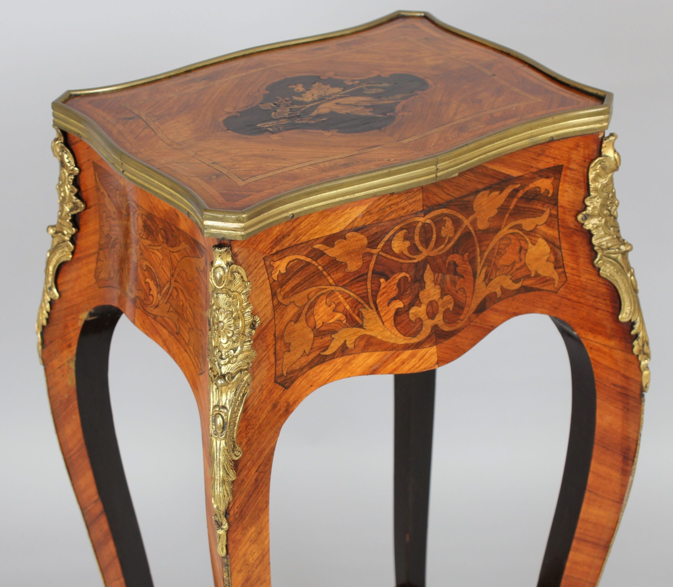 A mid nineteenth century French kingwood and marquetry table in the Louis XV manner