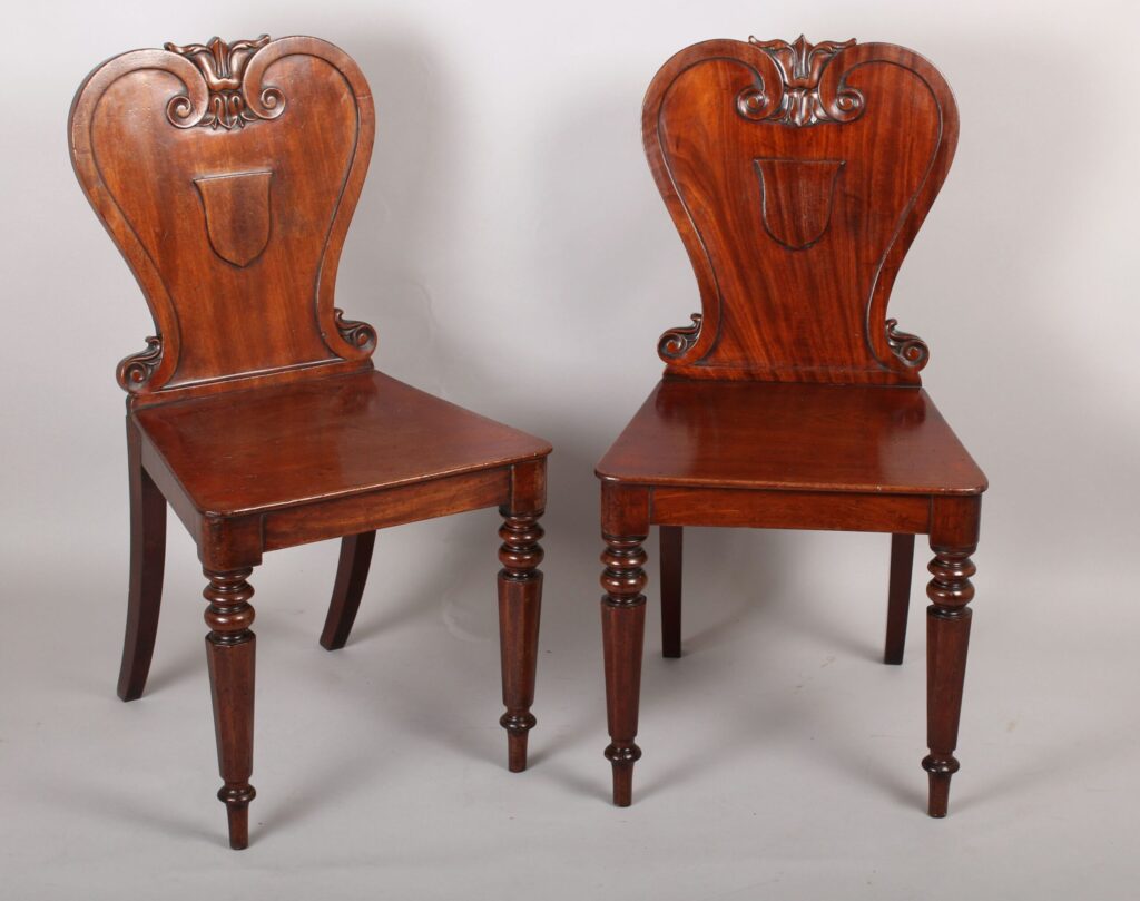 Pair of William IV period mahogany hall-chairs by Johnstone Jupe & Co., London