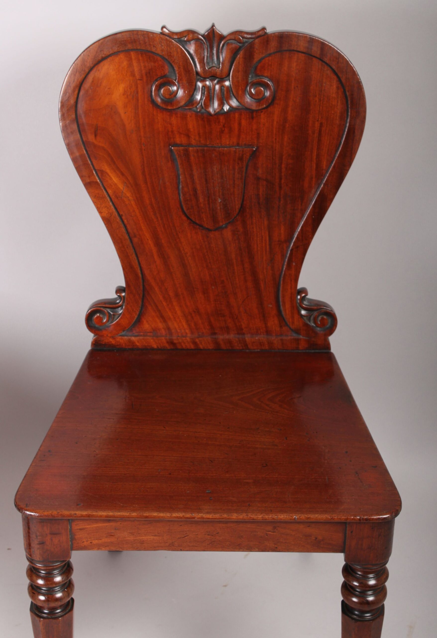 Pair of William IV period mahogany hall-chairs by Johnstone Jupe & Co., London