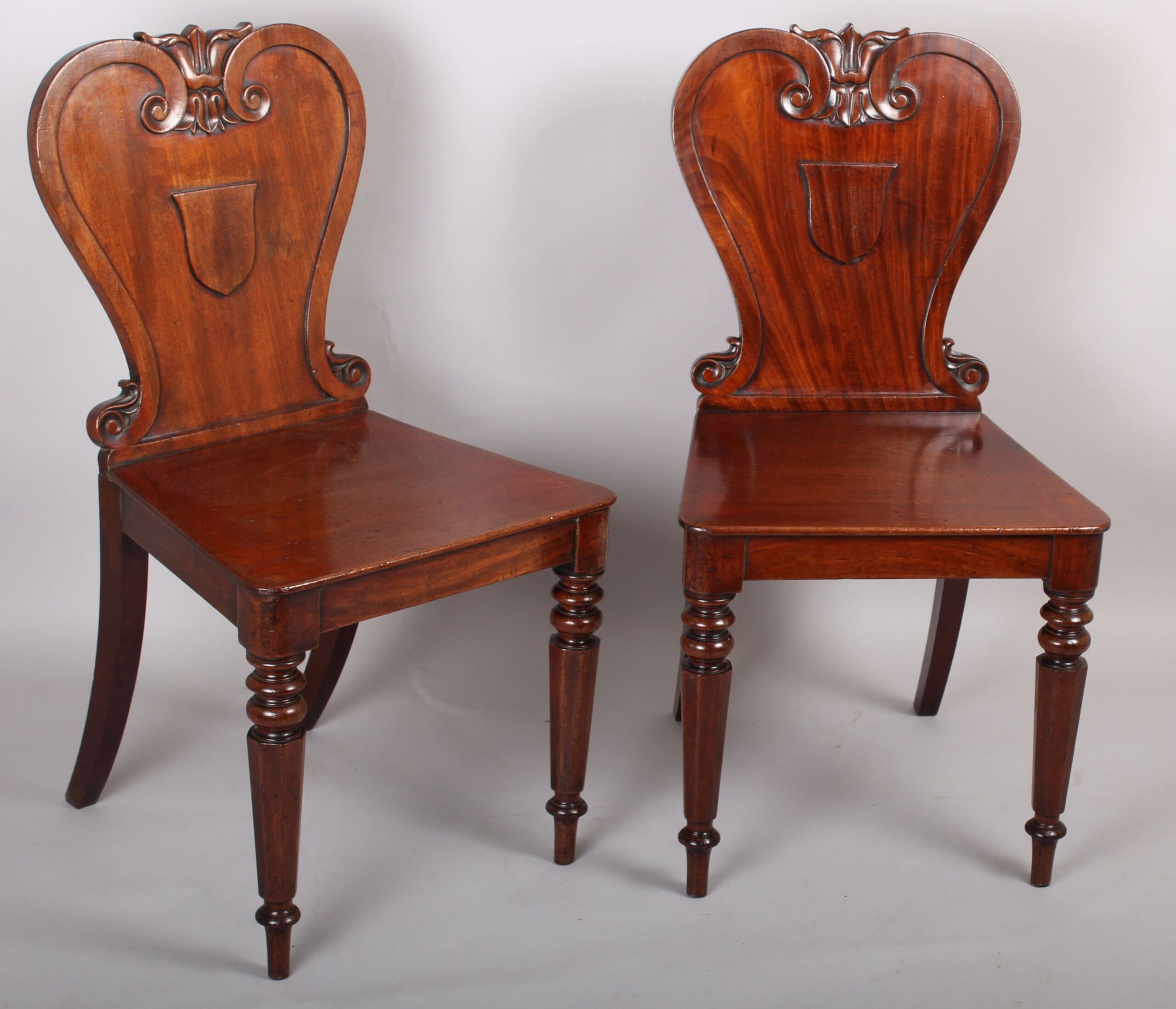 Pair of William IV period mahogany hall-chairs by Johnstone Jupe & Co., London