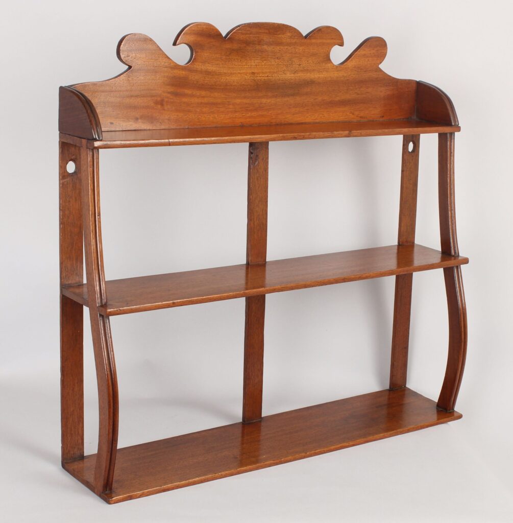Set of small George IV period pale mahogany hanging shelves