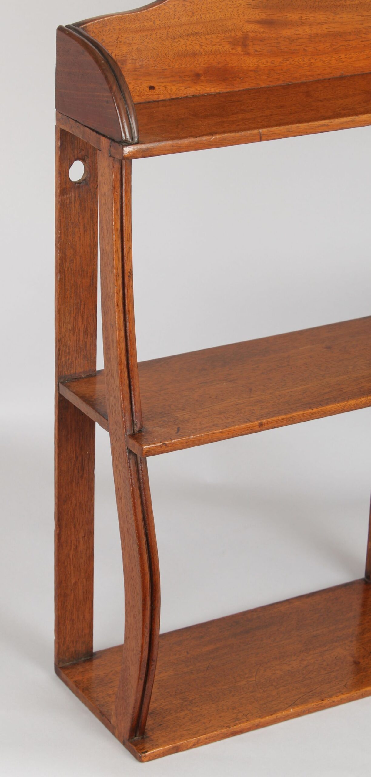Set of small George IV period pale mahogany hanging shelves