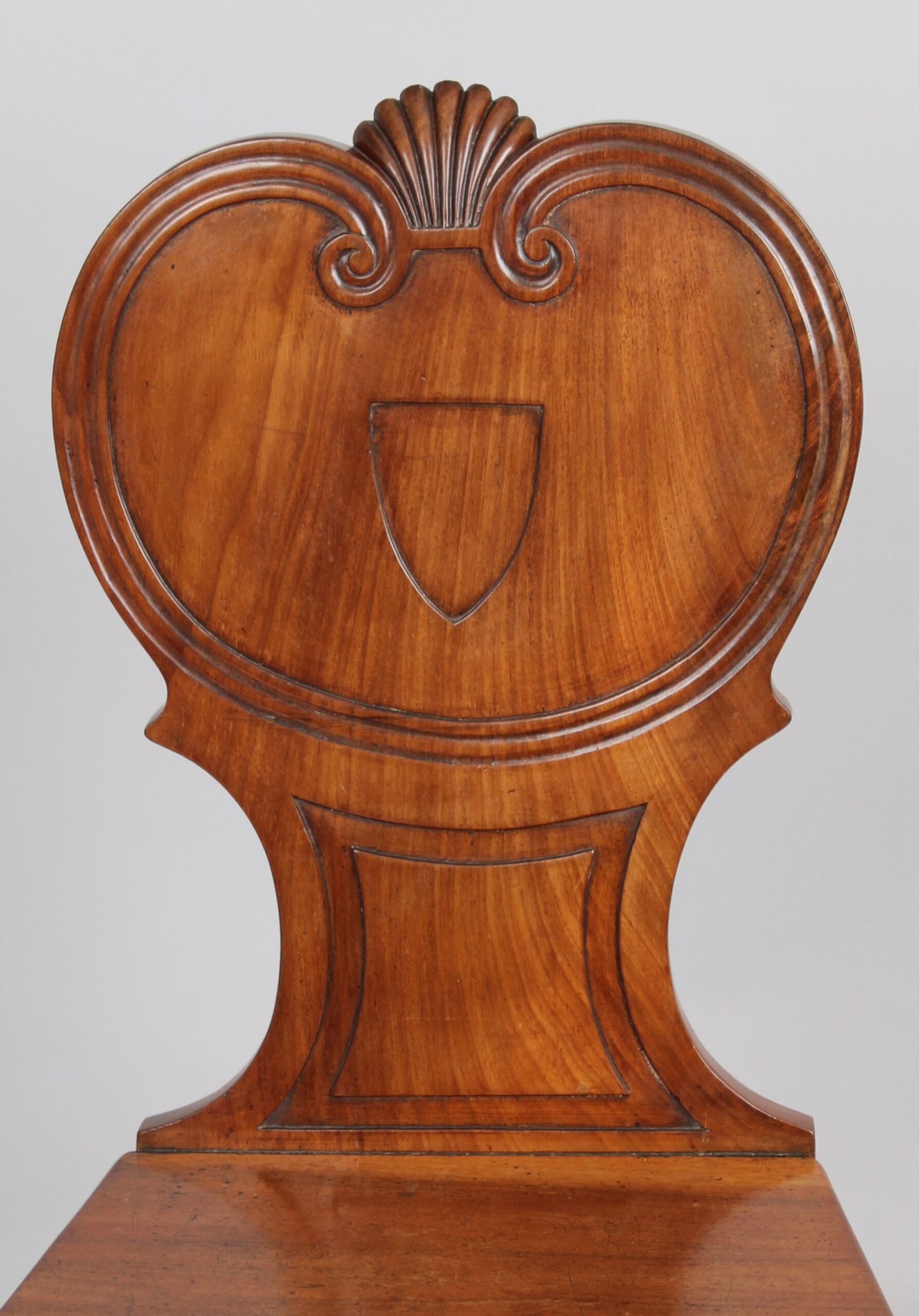 Pair of Regency period pale mahogany hall-chairs