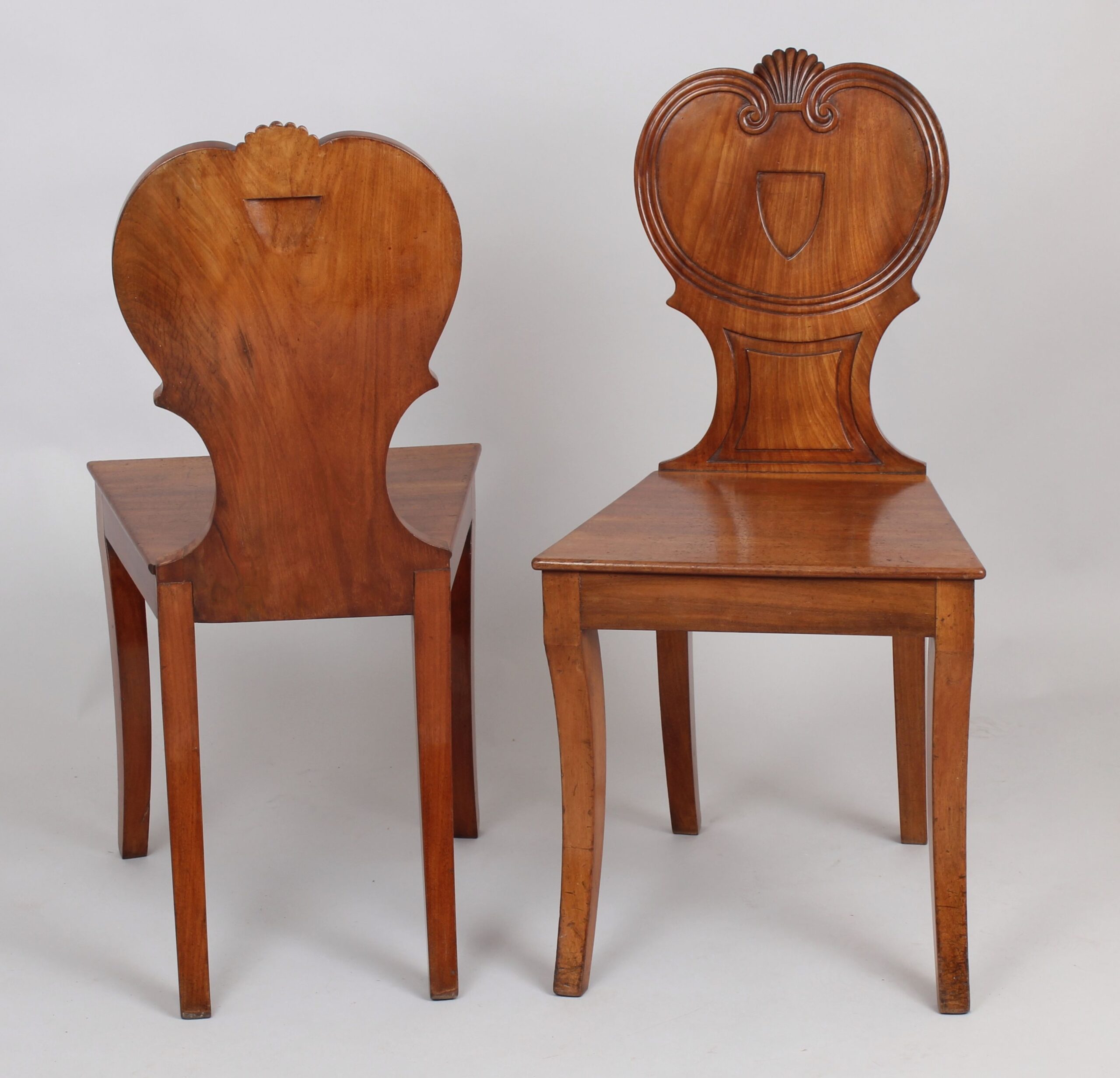 Pair of Regency period pale mahogany hall-chairs