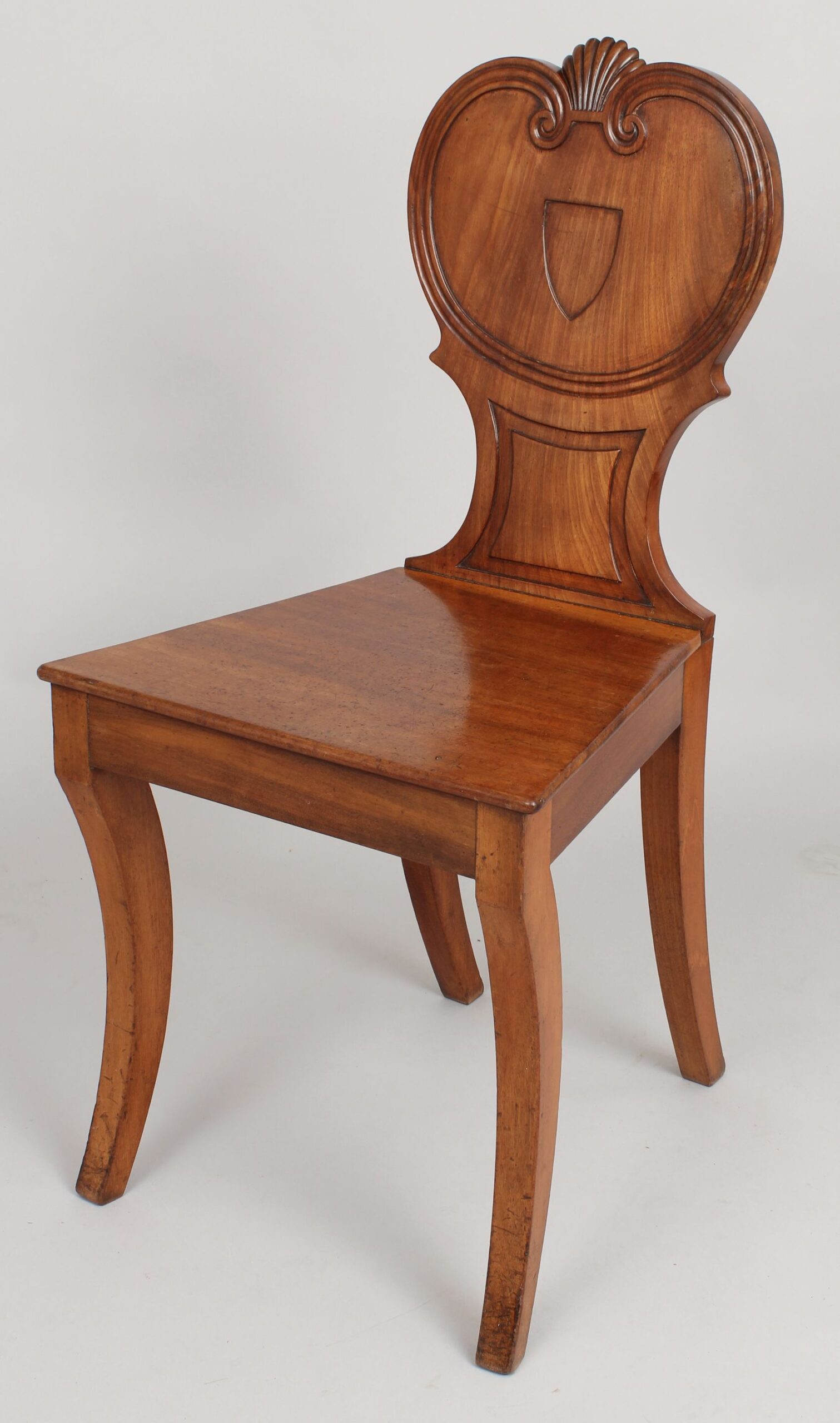 Pair of Regency period pale mahogany hall-chairs