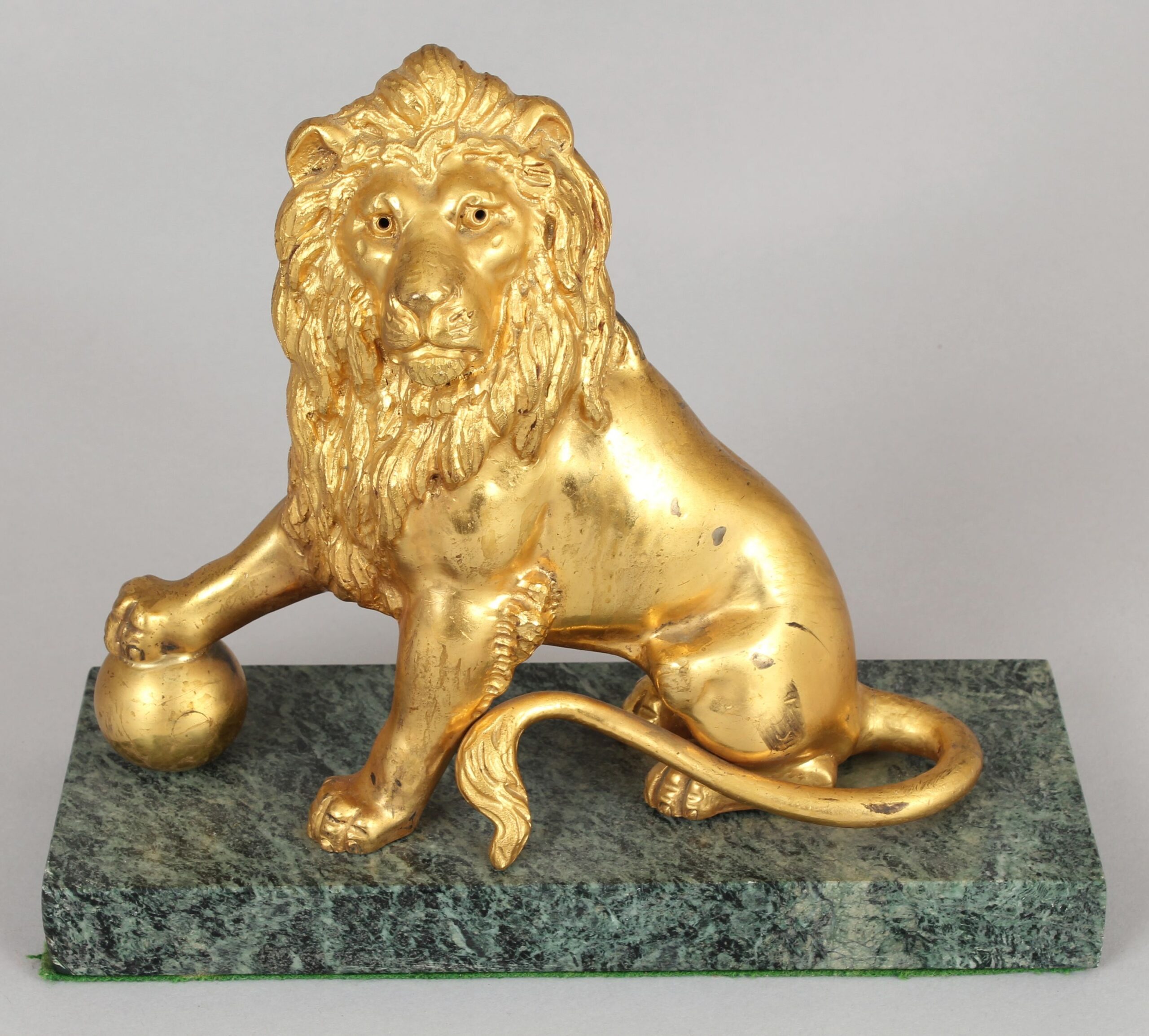 Pair of mid 19th century cast and chased ormolu figures of lions sejant