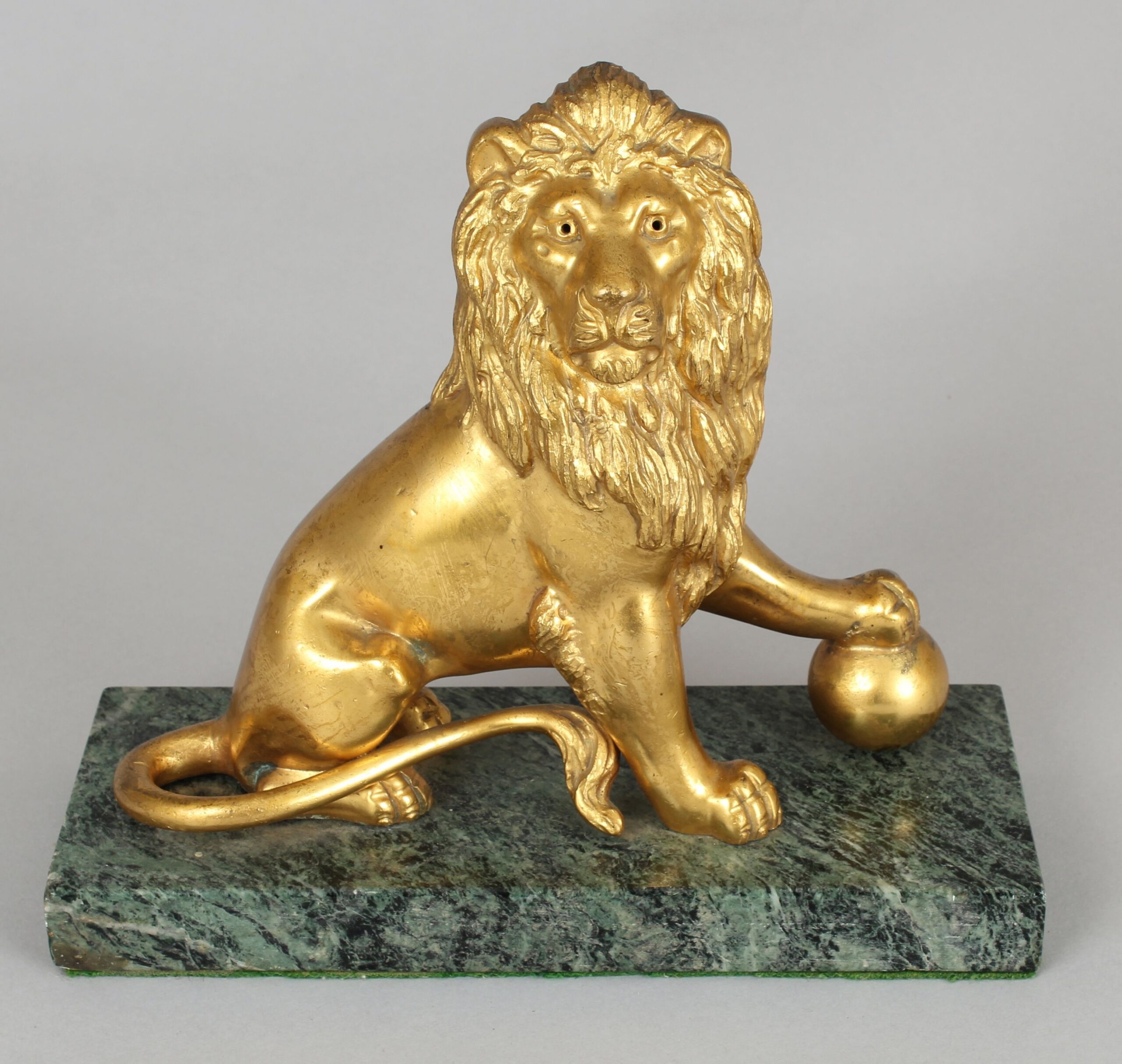 Pair of mid 19th century cast and chased ormolu figures of lions sejant