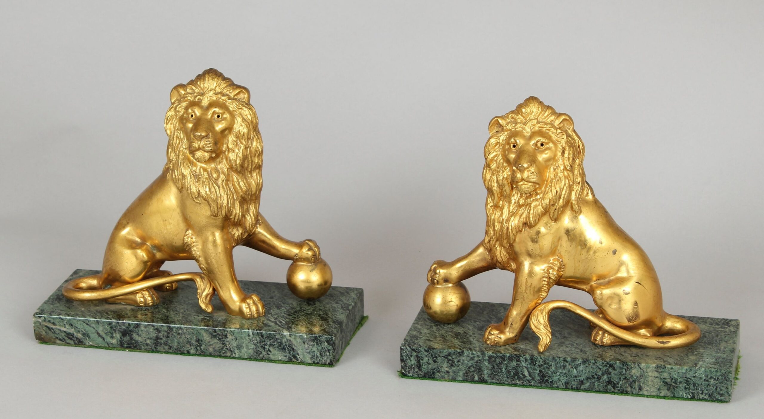 Pair of mid 19th century cast and chased ormolu figures of lions sejant