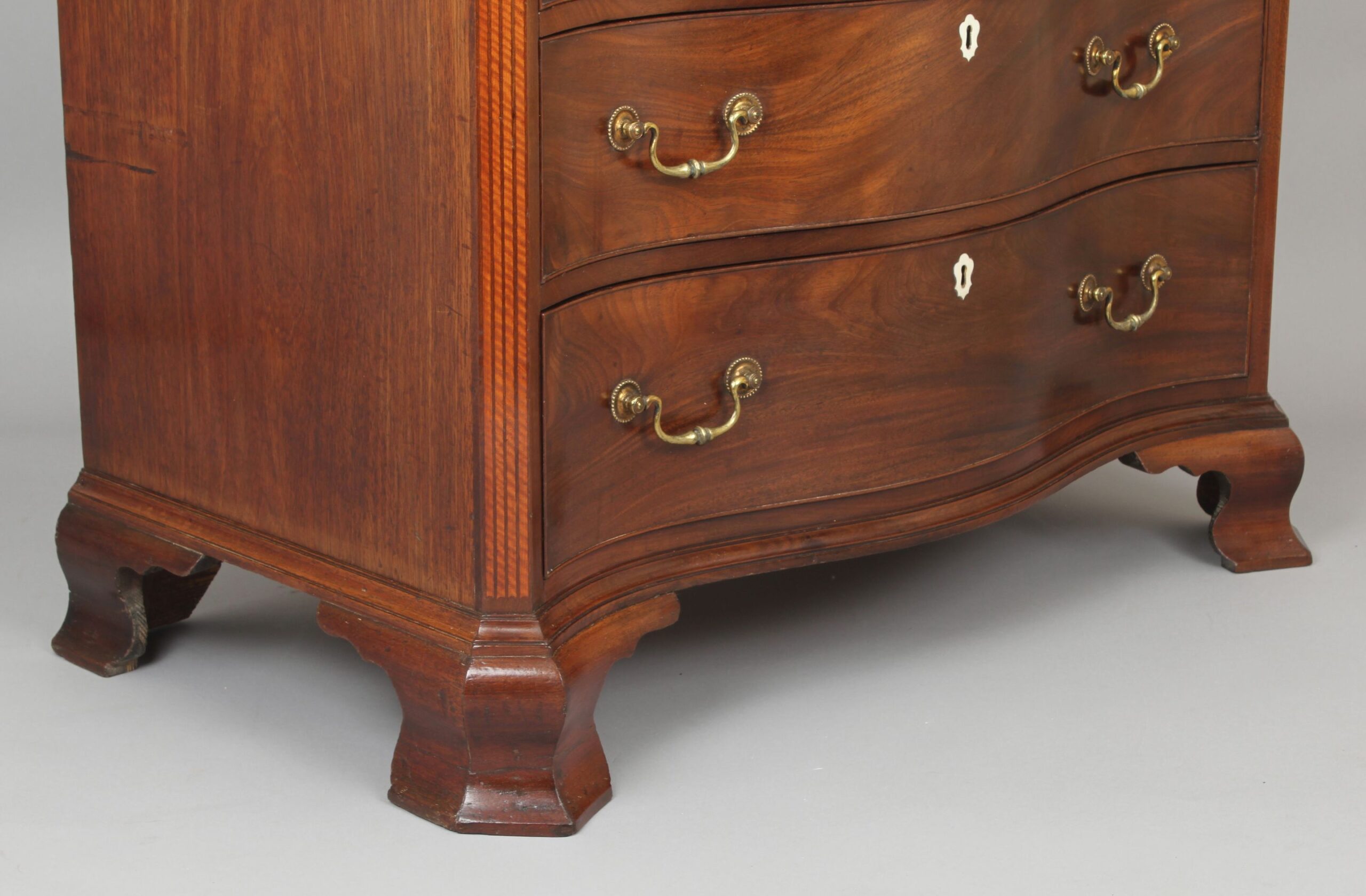 Fine George III period mahogany serpentine dressing-chest of small proportions