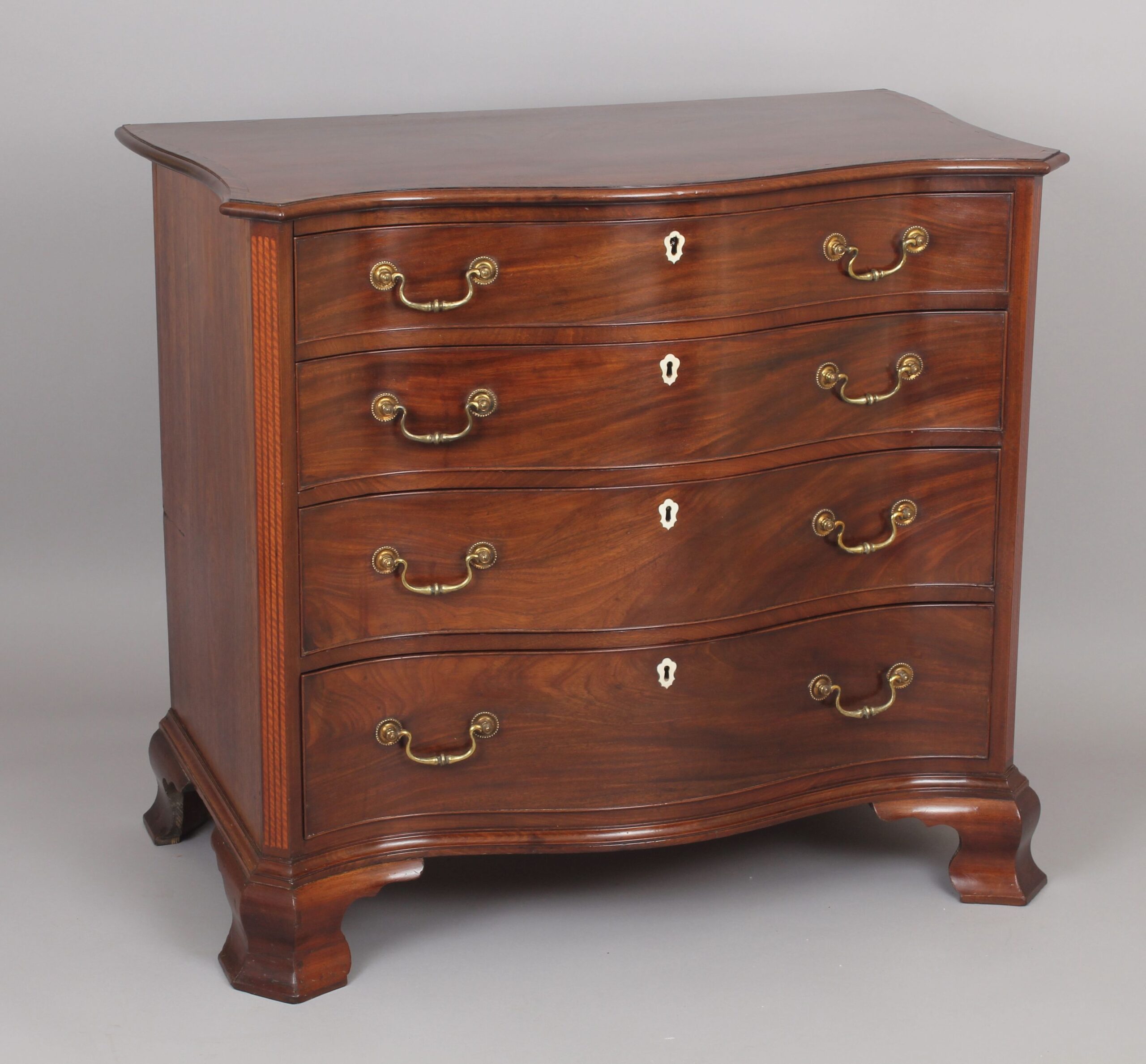 Fine George III period mahogany serpentine dressing-chest of small proportions