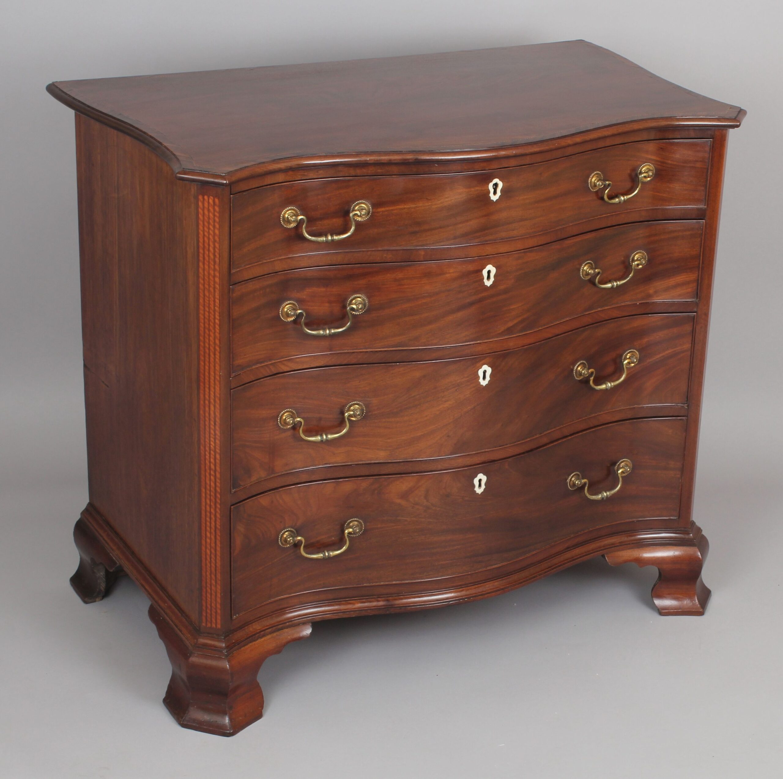 Fine George III period mahogany serpentine dressing-chest of small proportions