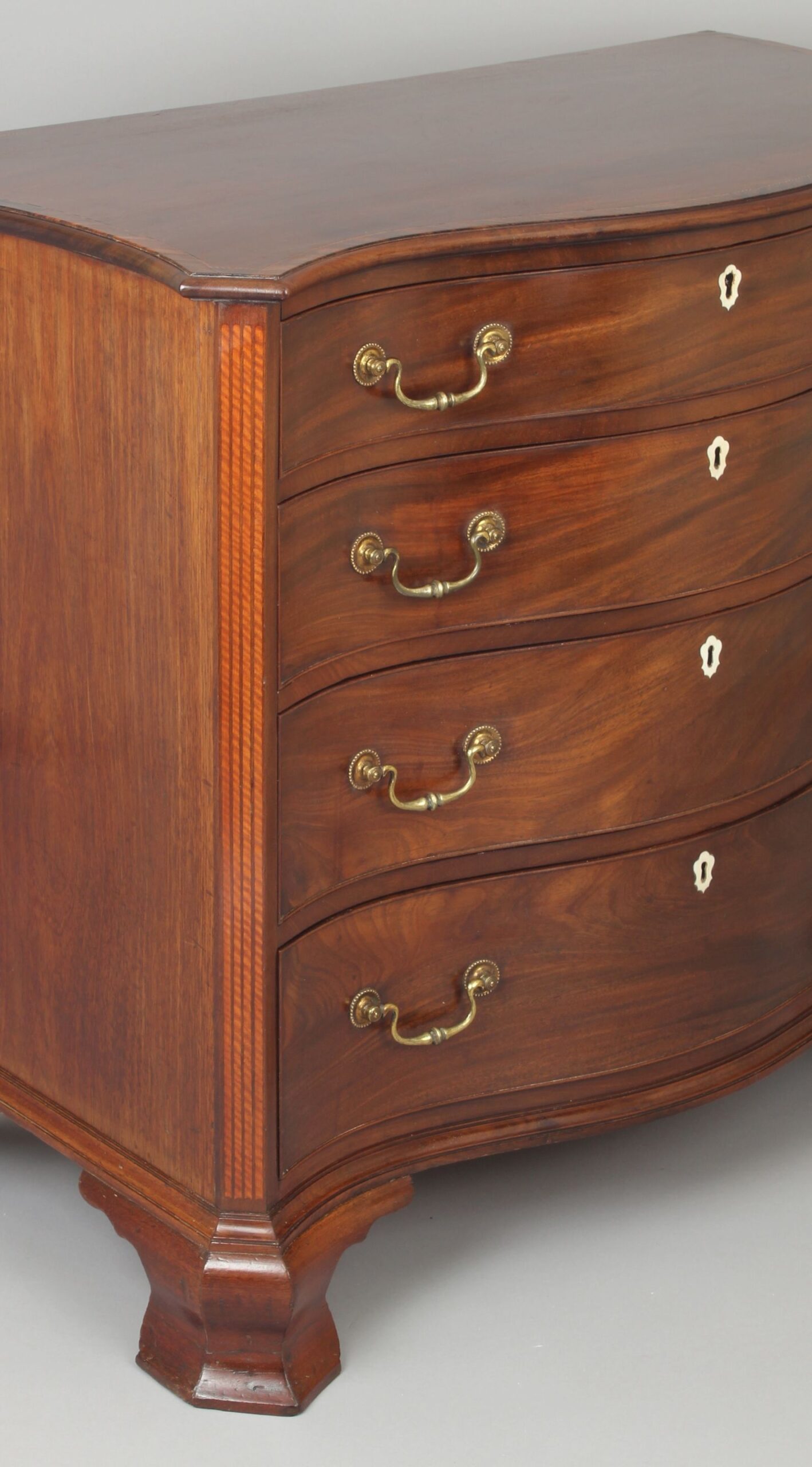 Fine George III period mahogany serpentine dressing-chest of small proportions