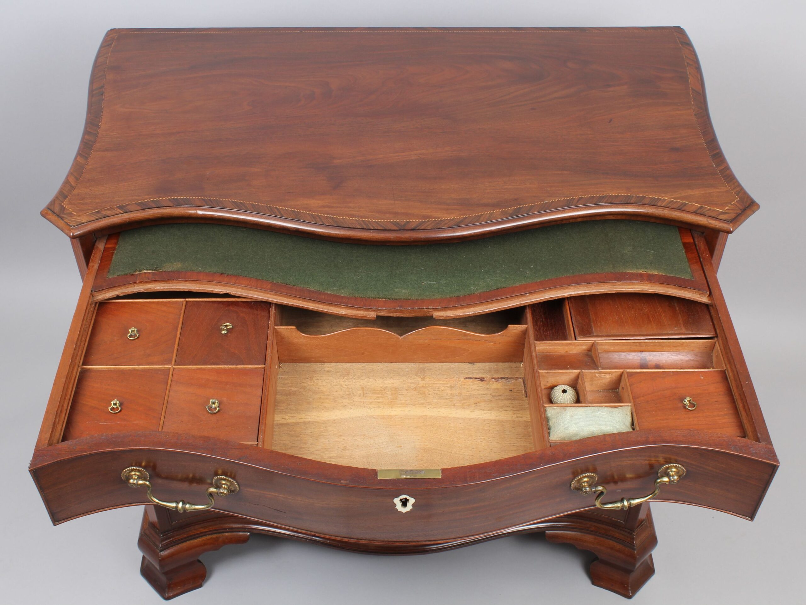 Fine George III period mahogany serpentine dressing-chest of small proportions