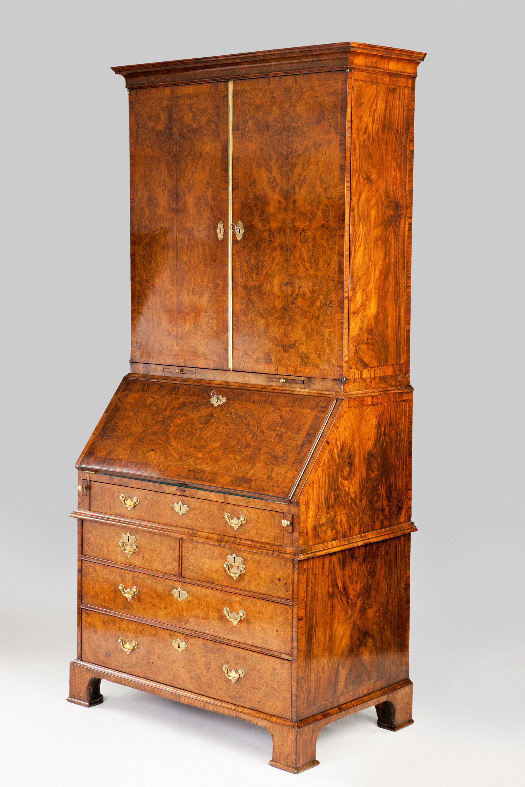 George II period burr walnut bureau-cabinet