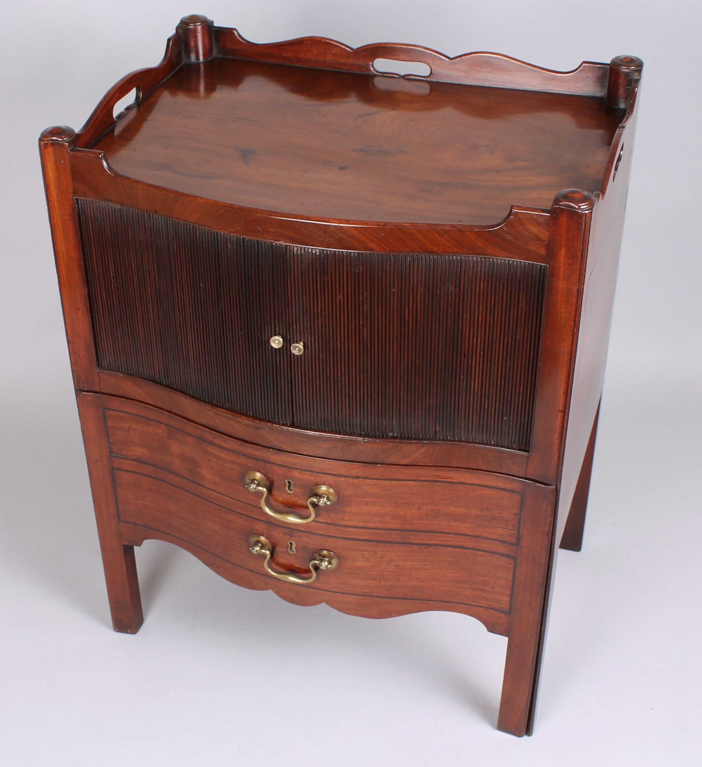 Rare George III period mahogany serpentine-fronted night-table