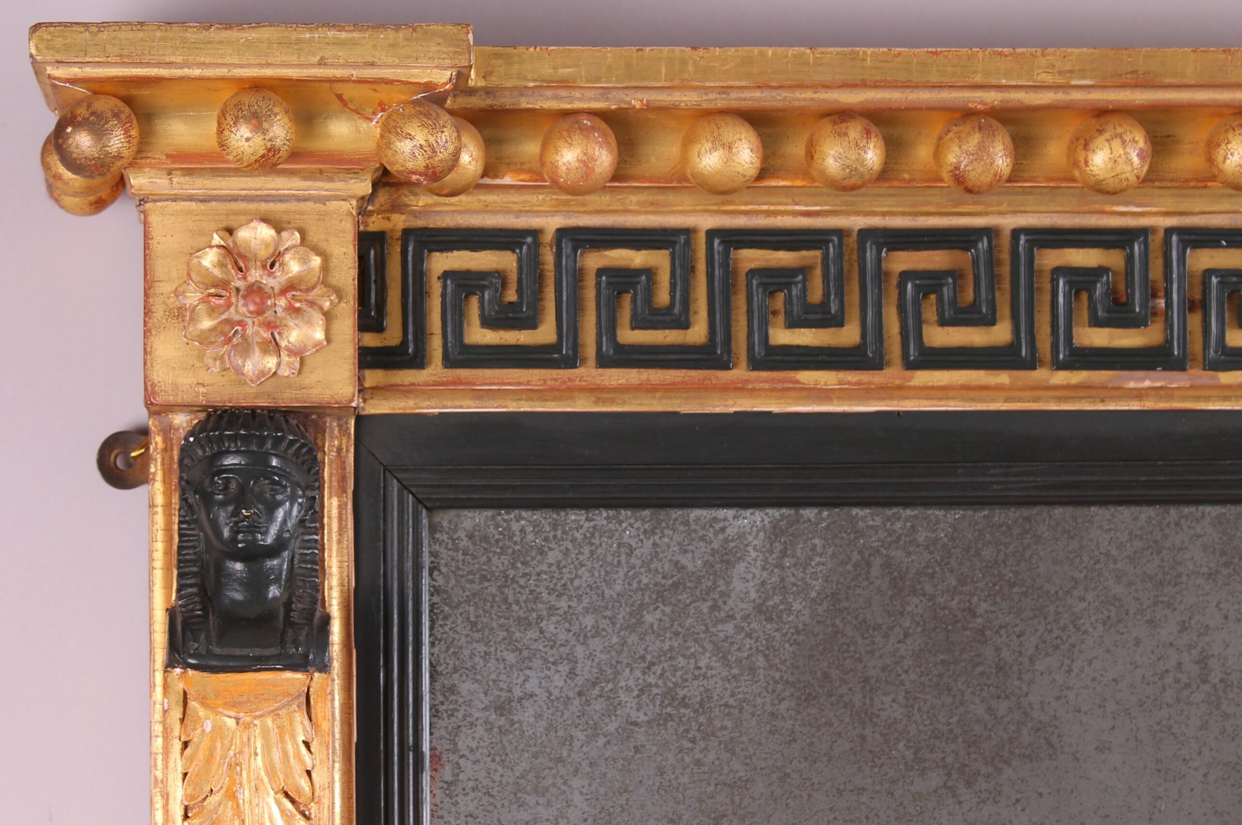 Fine Regency period gilt and ebonised overmantel mirror in the classical Egyptian taste