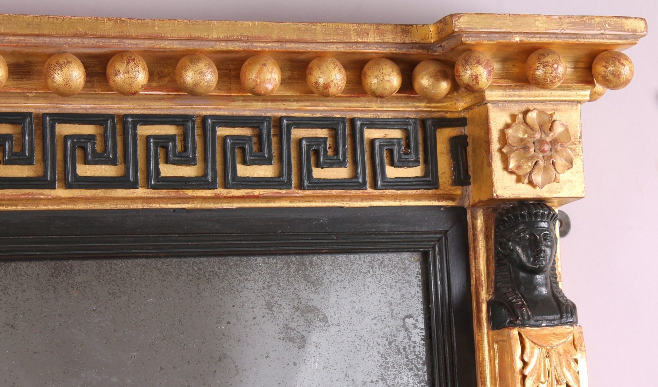 Fine Regency period gilt and ebonised overmantel mirror in the classical Egyptian taste