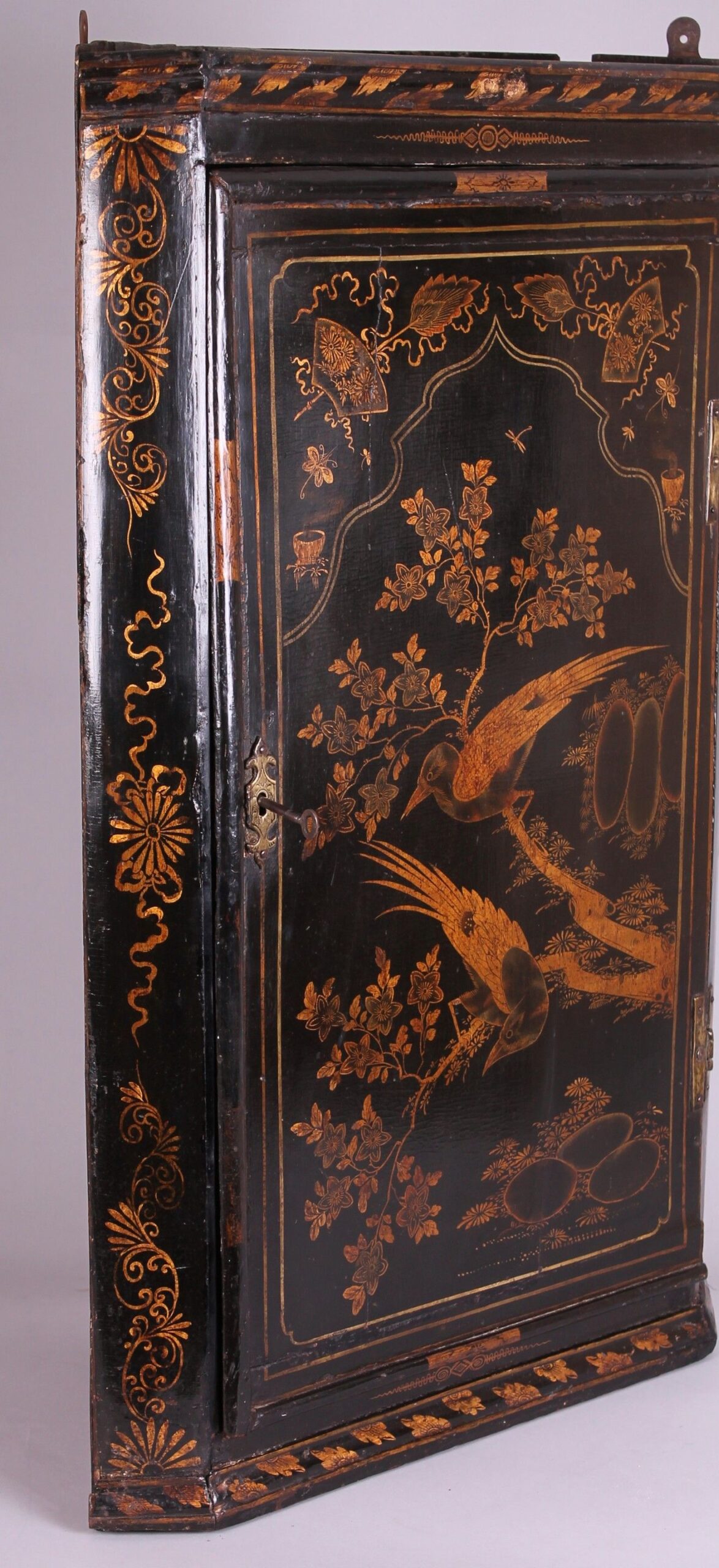 Early 18th century black and gold japanned corner-cupboard