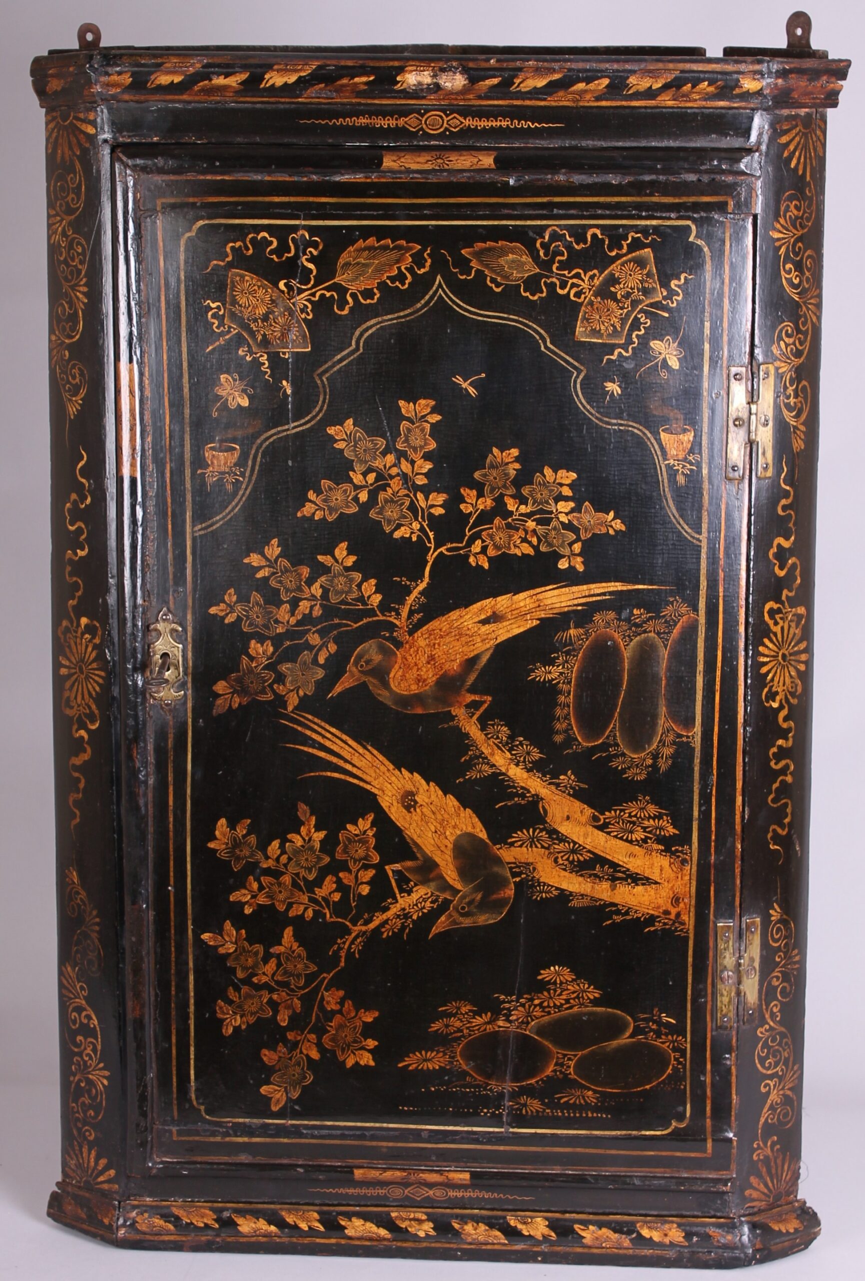 Early 18th century black and gold japanned corner-cupboard