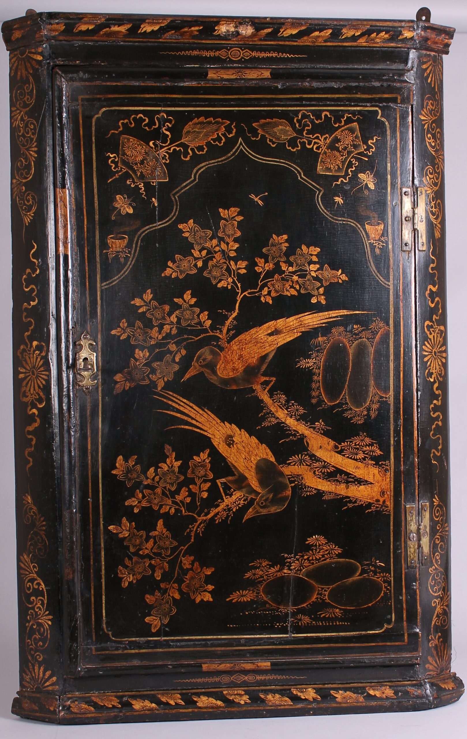 Early 18th century black and gold japanned corner-cupboard
