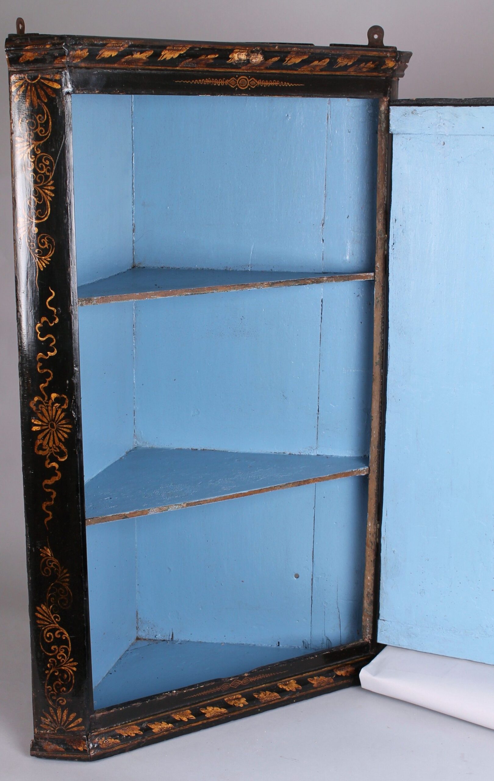 Early 18th century black and gold japanned corner-cupboard
