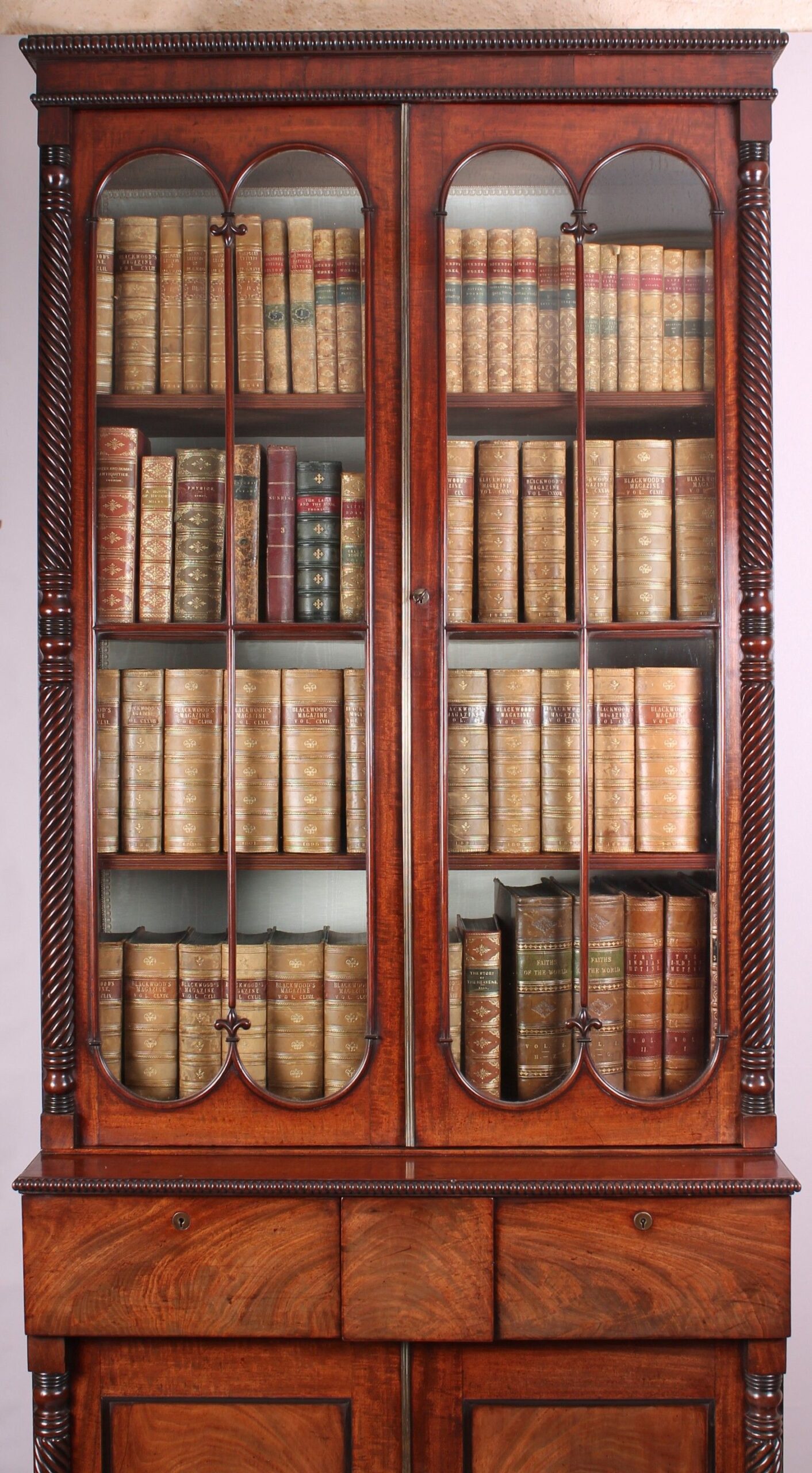 Fine George IV period mahogany bookcase-cabinet of high quality and narrow proportions