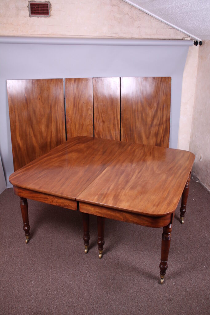 A good George IV period golden mahogany extending dining-table