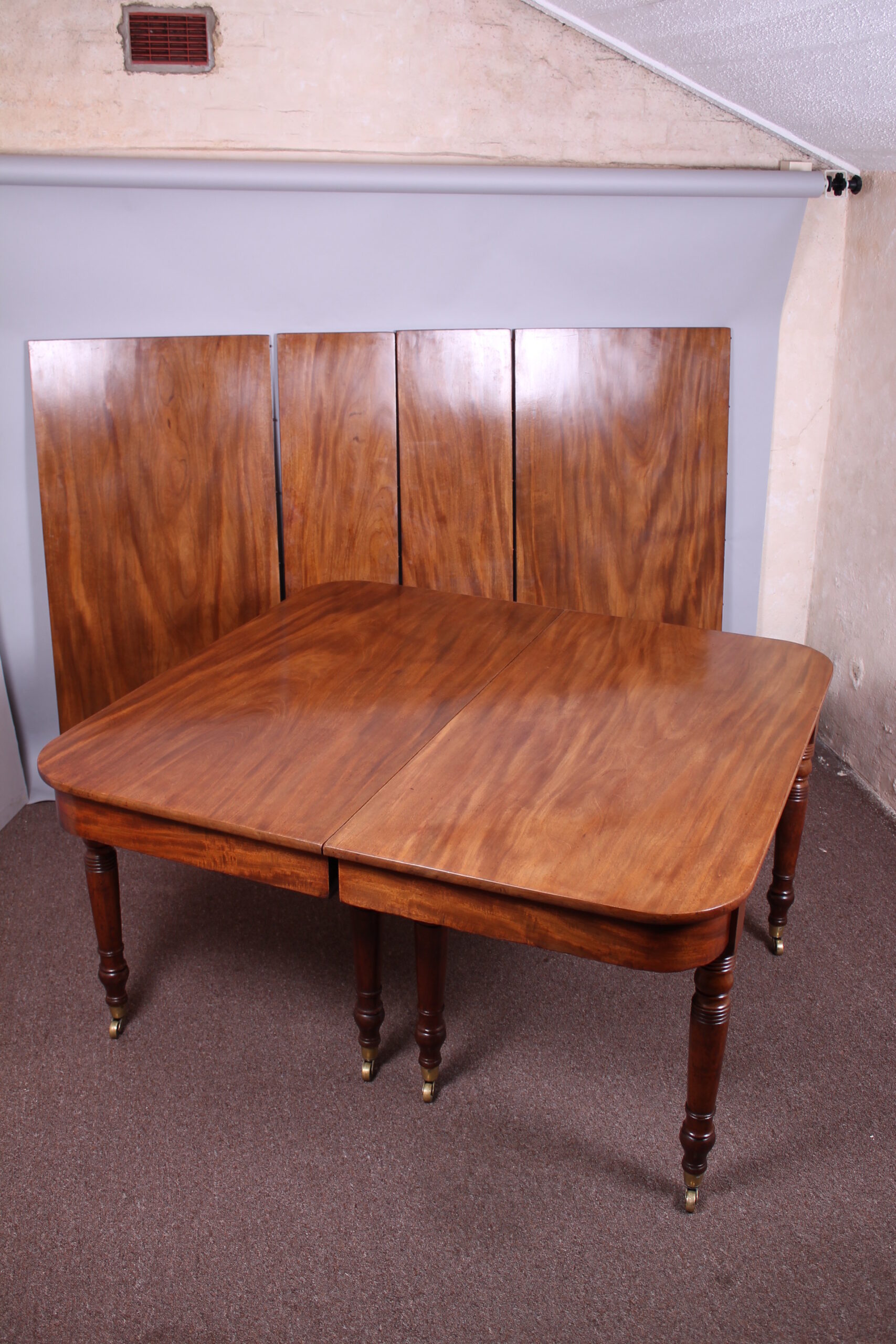 A good George IV period golden mahogany extending dining-table