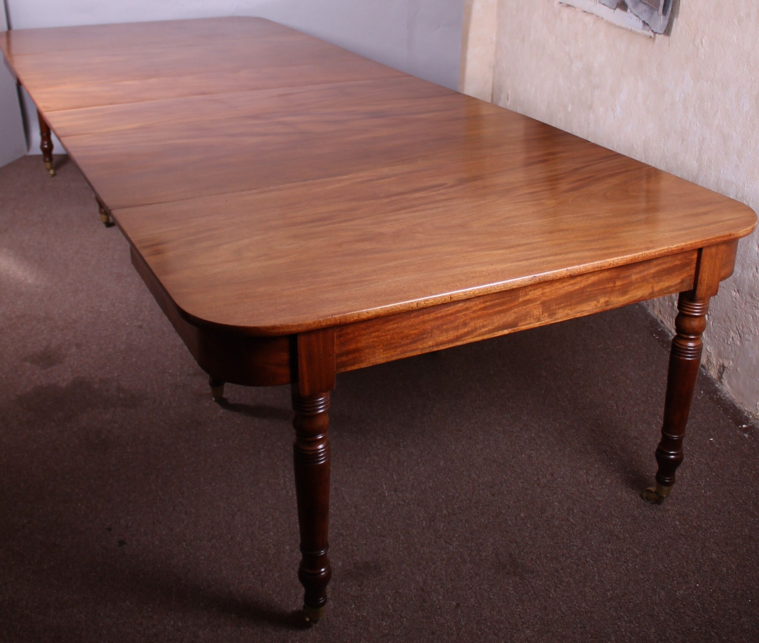 A good George IV period golden mahogany extending dining-table