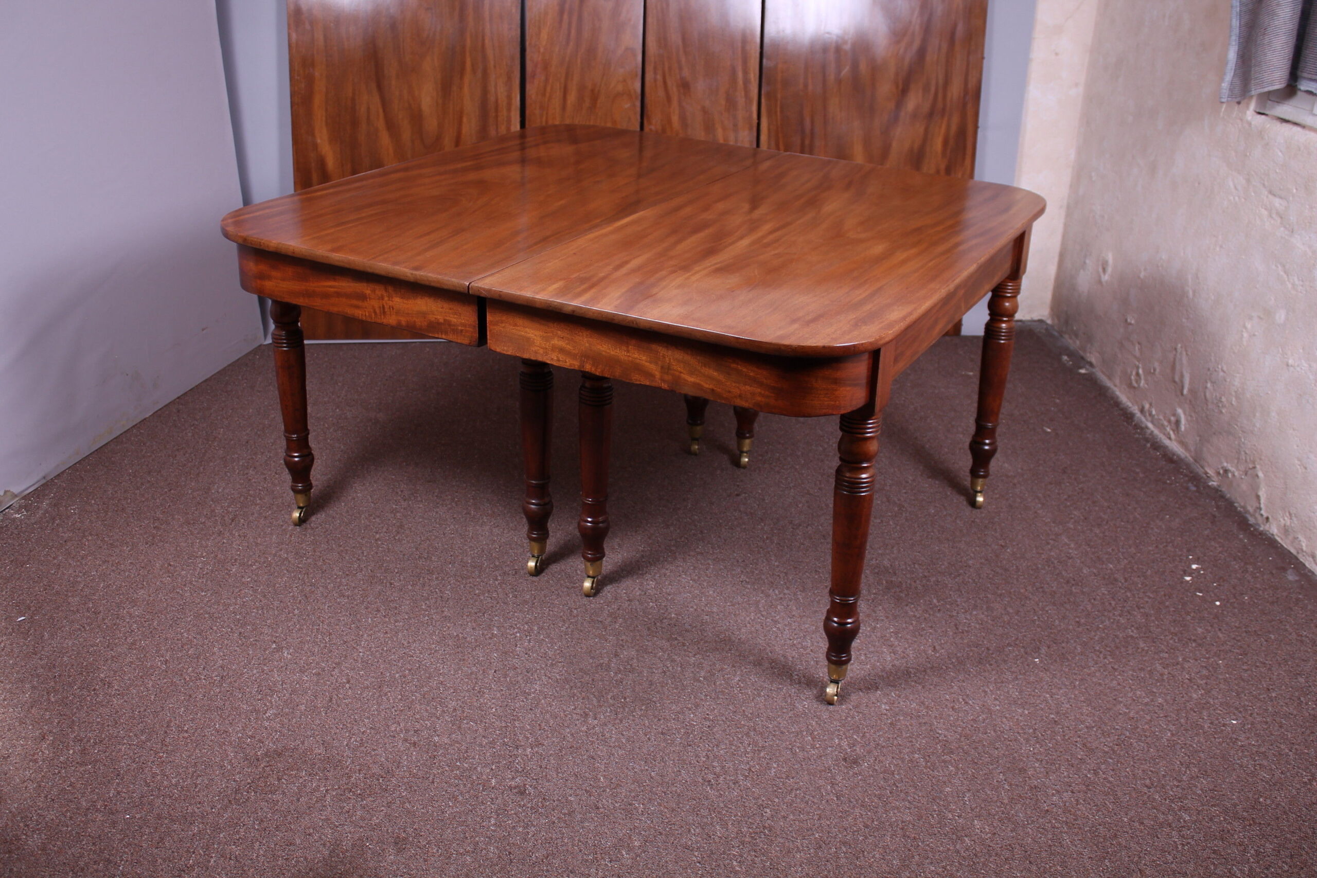 A good George IV period golden mahogany extending dining-table