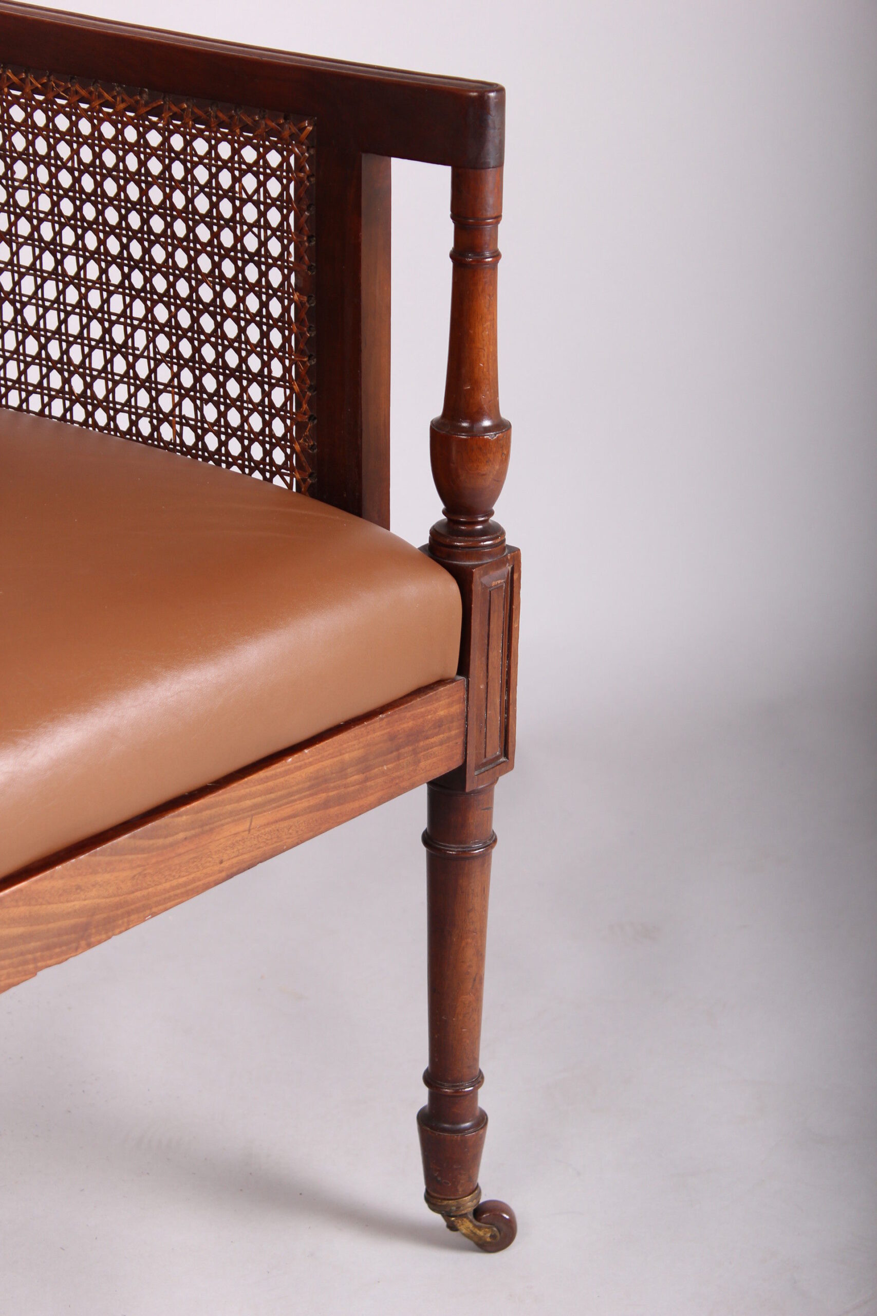 Late 19th century mahogany library bergere in the Regency manner