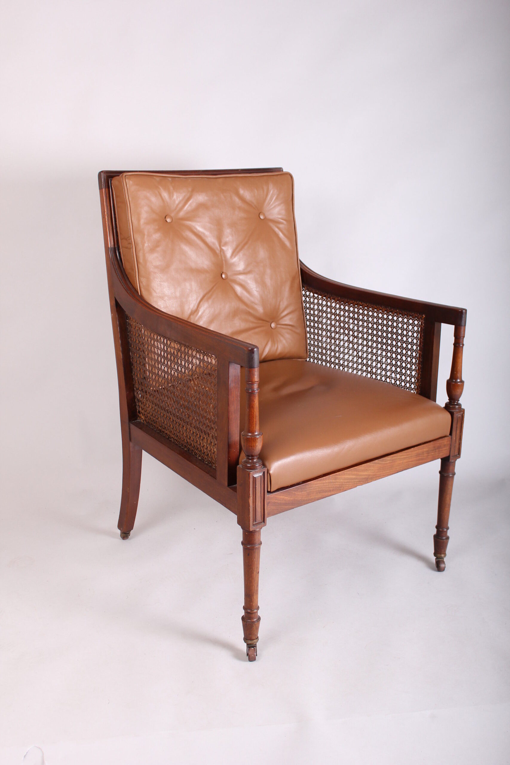 Late 19th century mahogany library bergere in the Regency manner