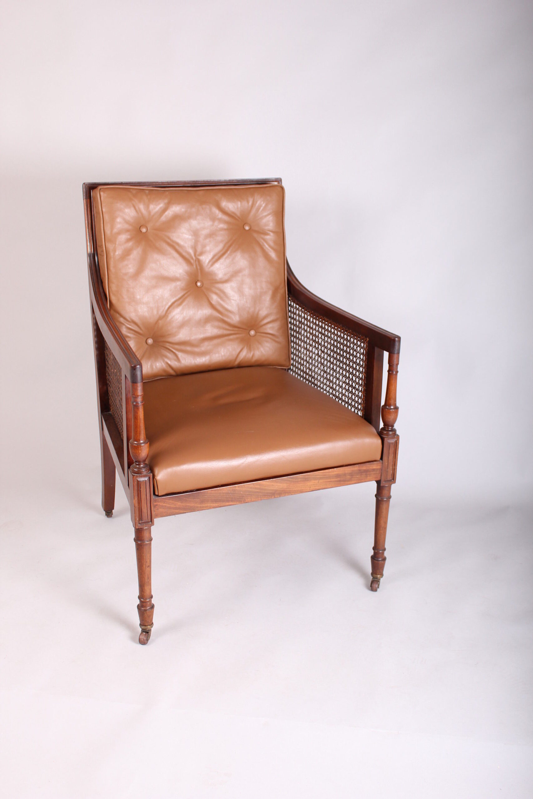 Late 19th century mahogany library bergere in the Regency manner