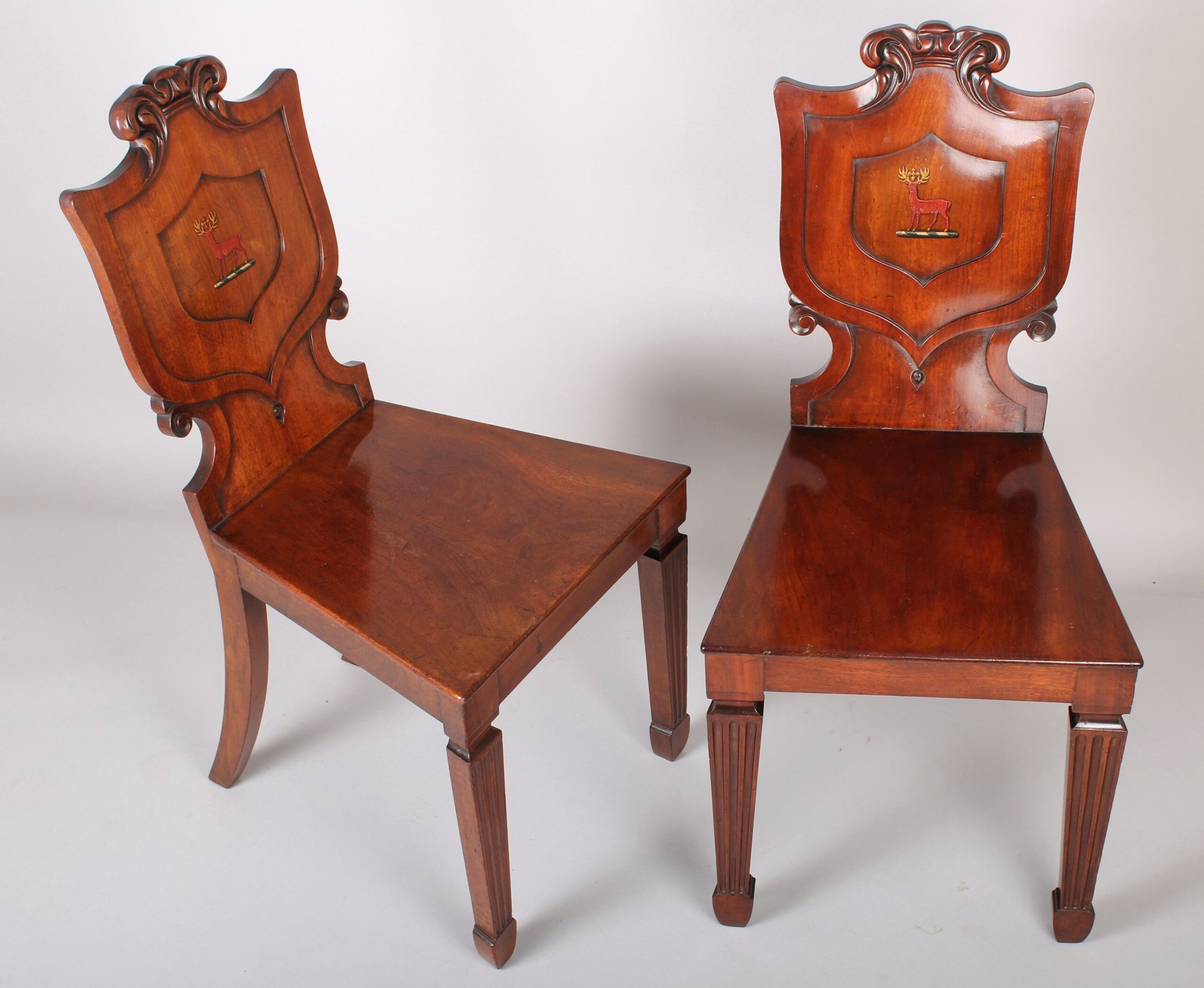 A fine pair of George IV period mahogany hall-chairs in the manner of T & G Seddon