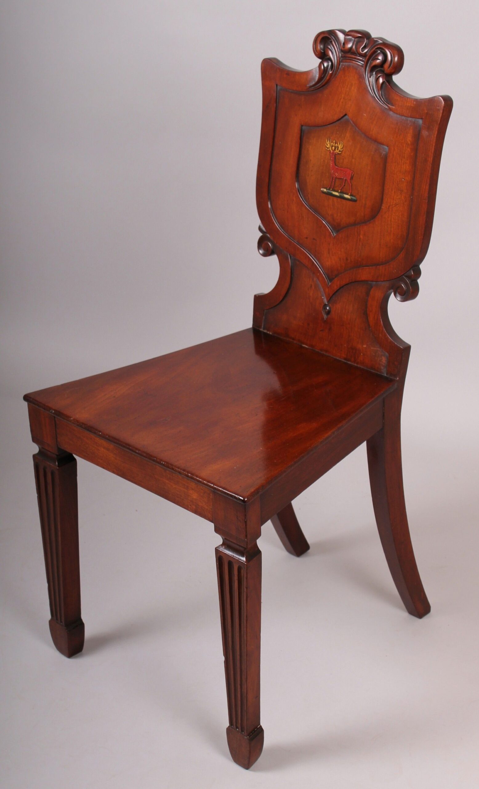 A fine pair of George IV period mahogany hall-chairs in the manner of T & G Seddon