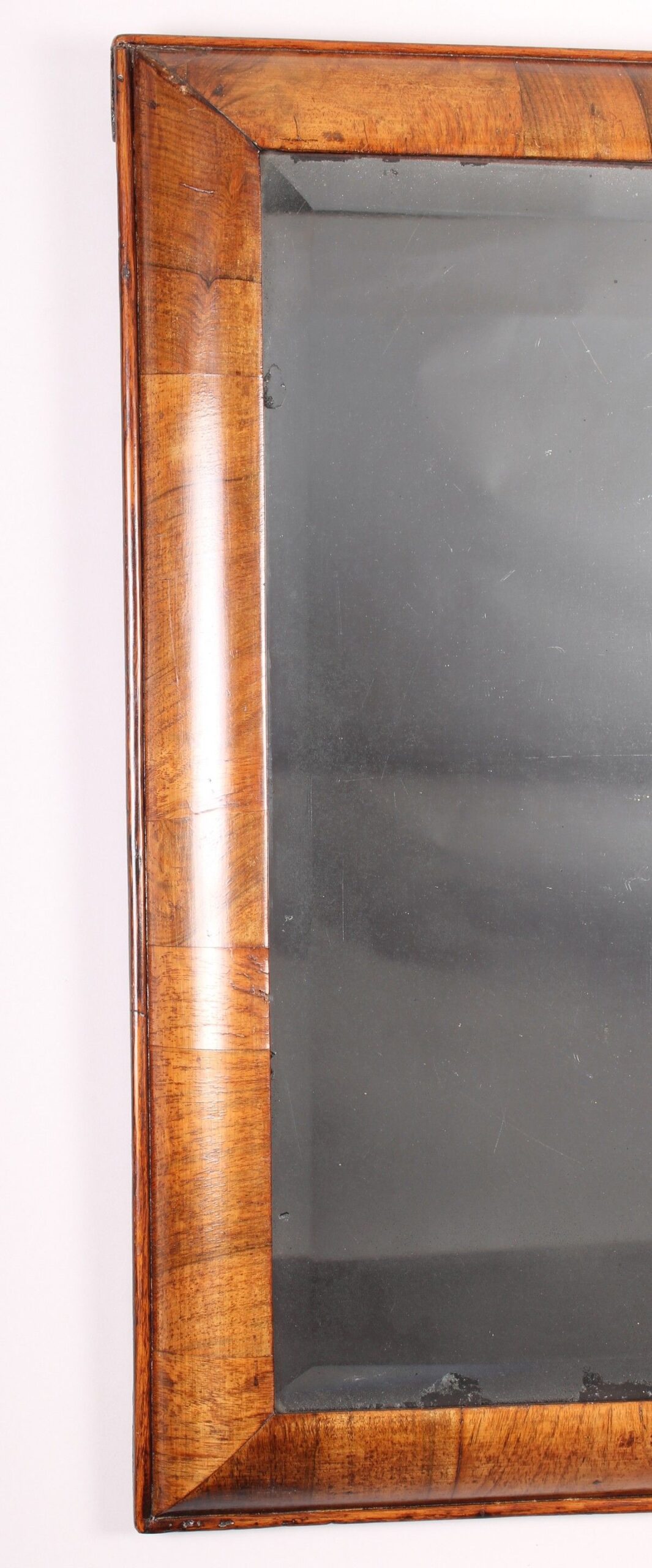 Early 18th century walnut cushion-frame mirror