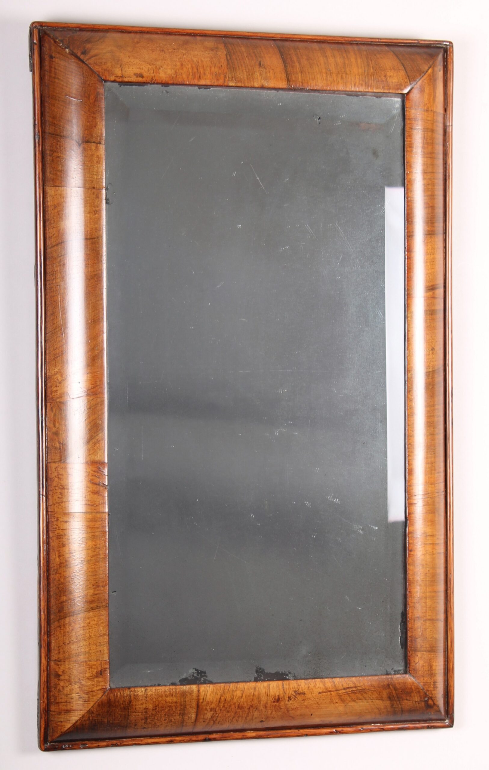 Early 18th century walnut cushion-frame mirror