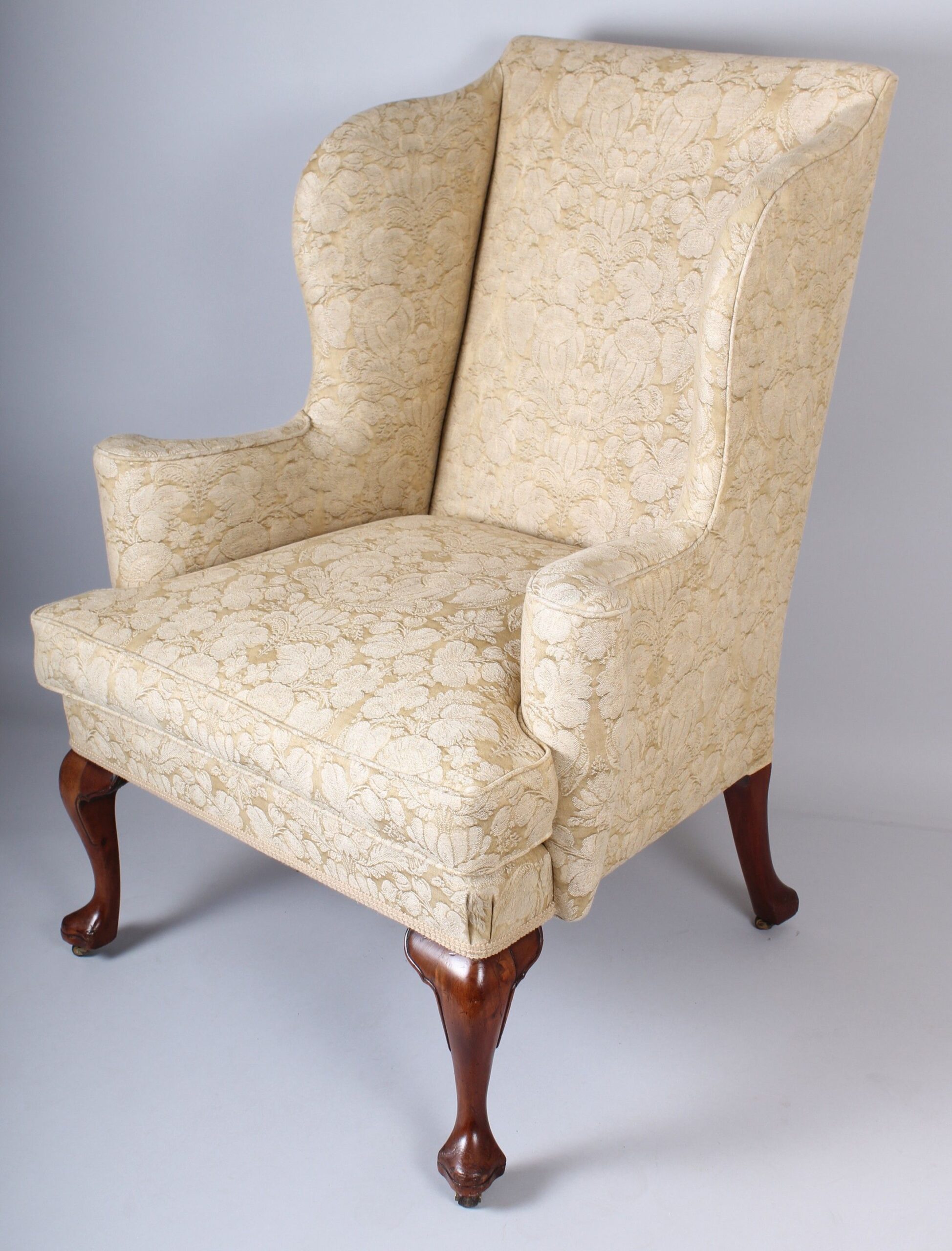 Wing arm-chair on walnut cabriole legs in the classic Queen Anne style