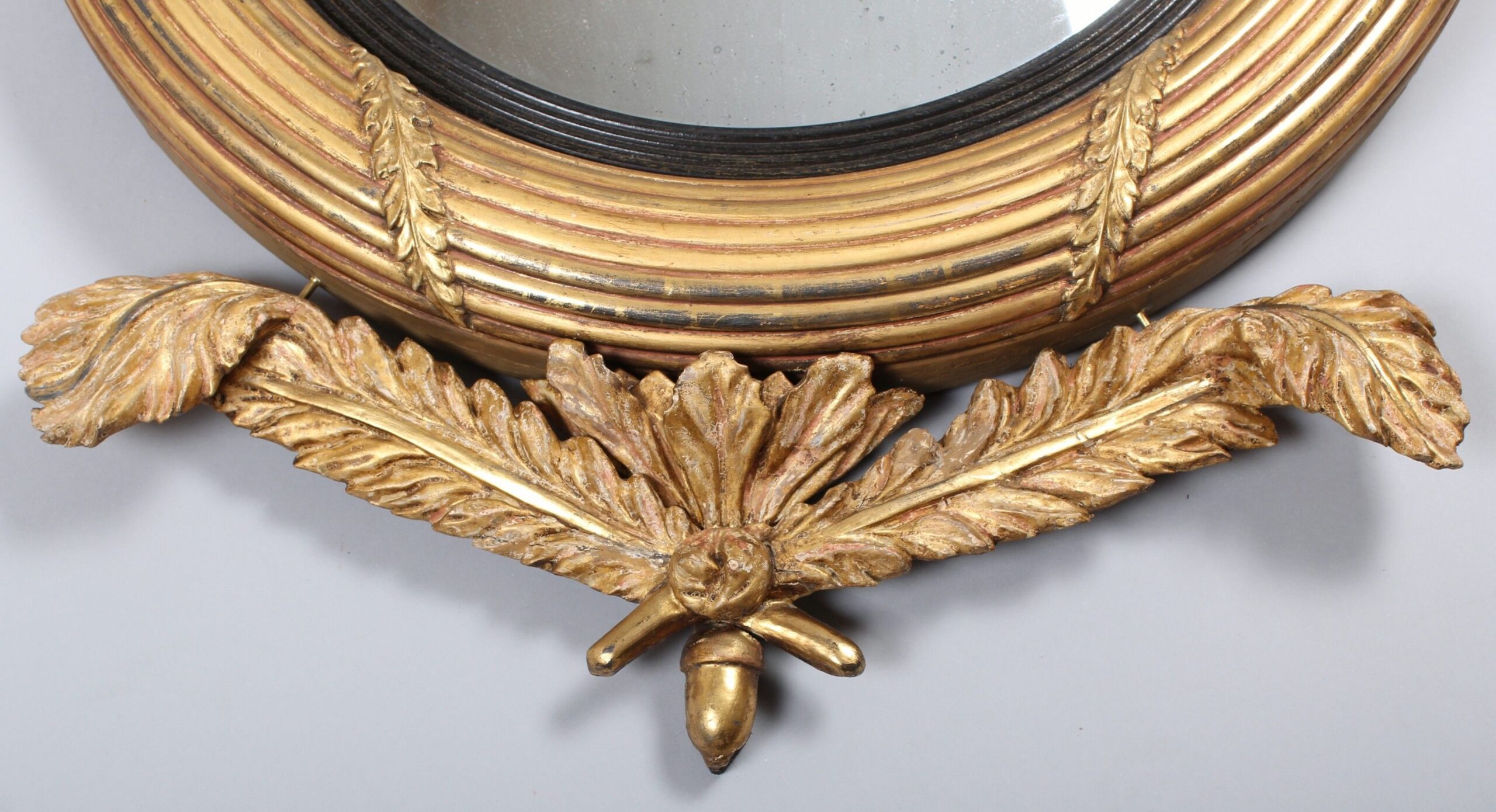 Regency period carved and gilt wood convex mirror