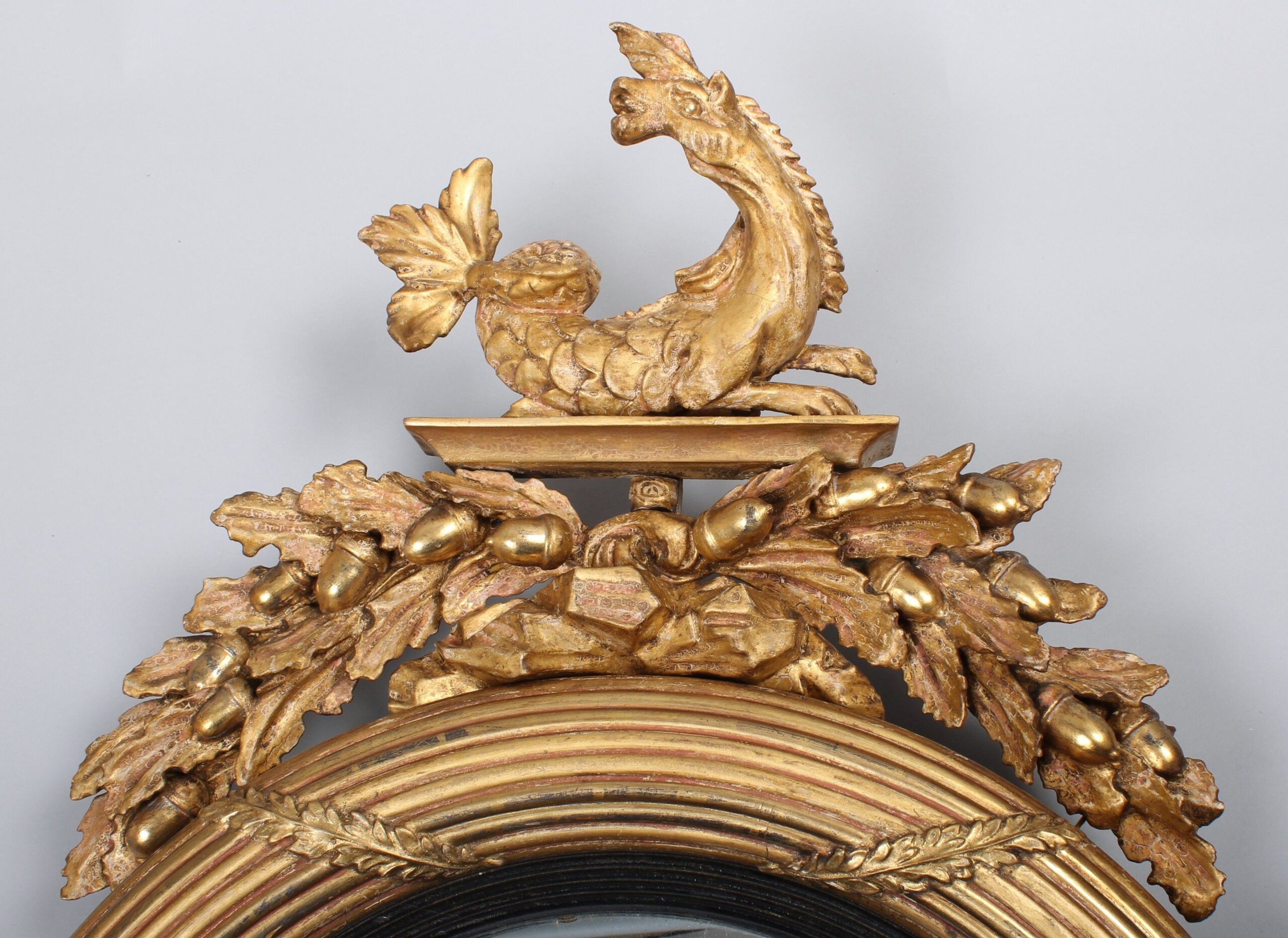 Regency period carved and gilt wood convex mirror