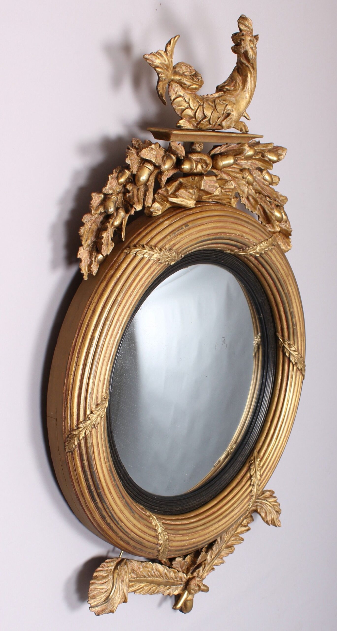 Regency period carved and gilt wood convex mirror
