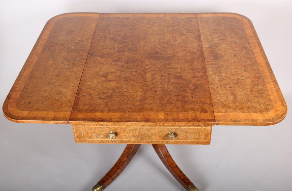A spectacular Regency burr elm Pembroke table
