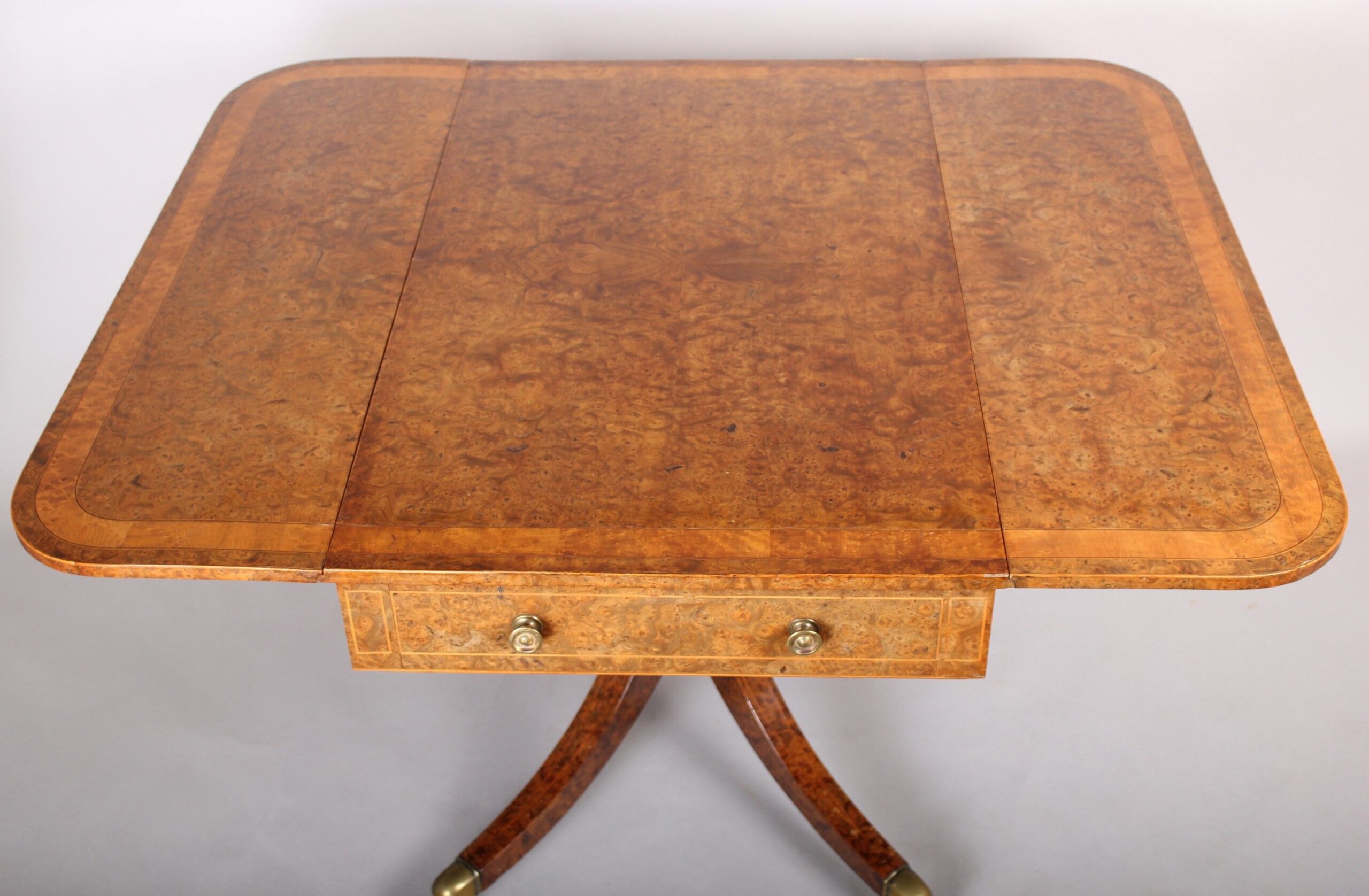 A spectacular Regency burr elm Pembroke table