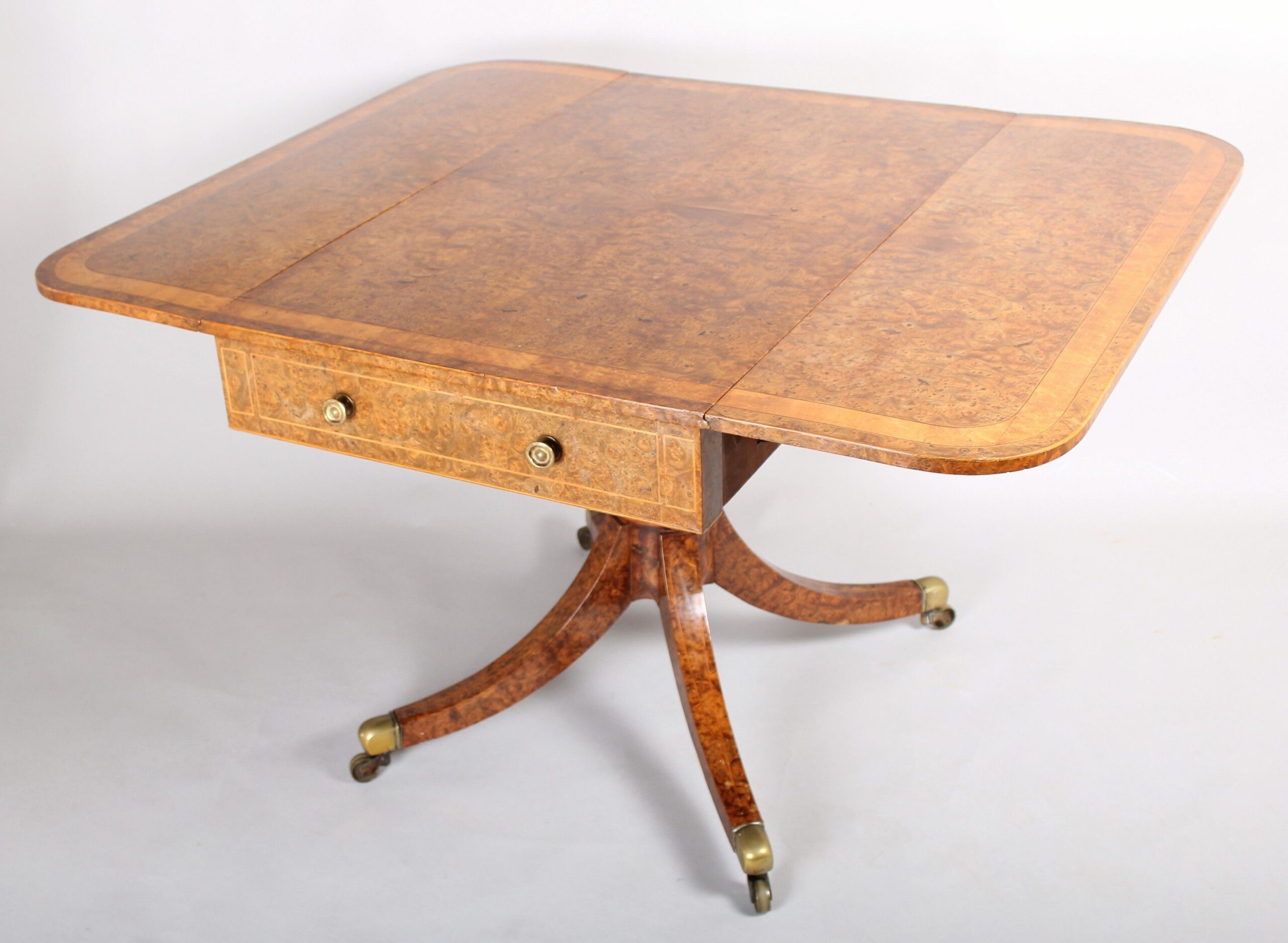 A spectacular Regency burr elm Pembroke table