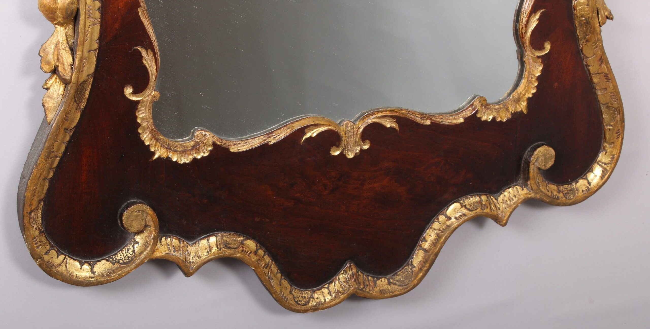 A fine and handsome George II period mahogany and parcel-gilt mirror