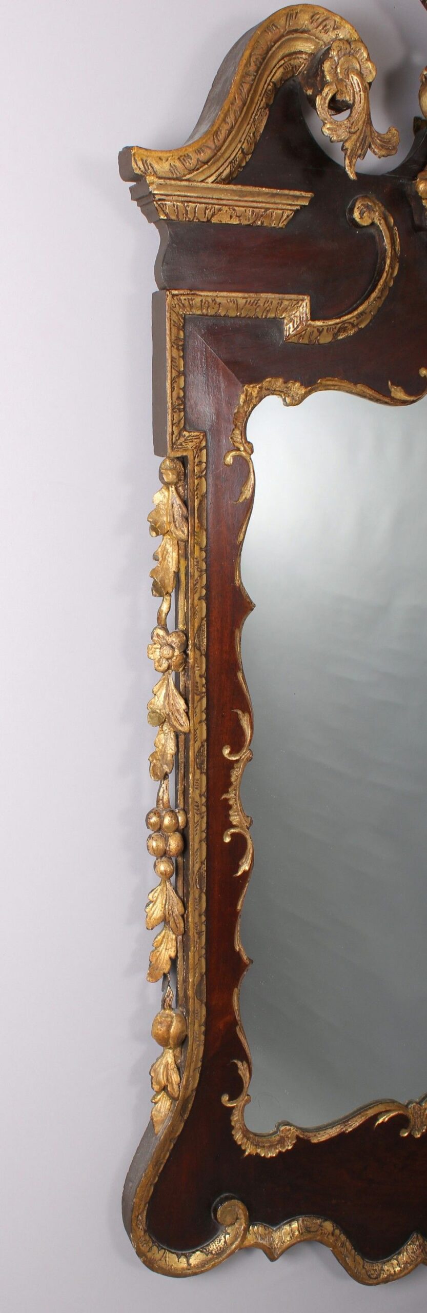 A fine and handsome George II period mahogany and parcel-gilt mirror